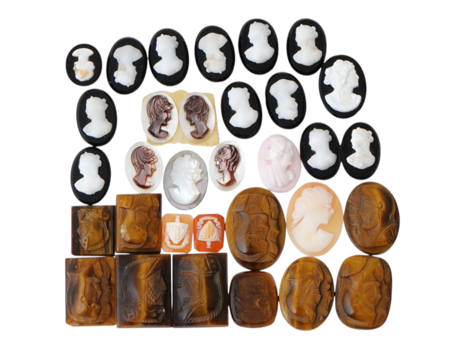 COLLECTION OF ANTIQUE HAND CARVED CAMEOS: A collection of antique hand carved cameos, dating to the late 19th to early 20th century. A total of 32 items. Each piece is crafted from conch shell and stone, featuring knights in armor, female