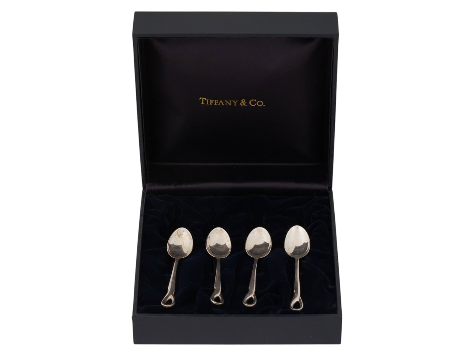 FOUR VINTAGE TIFFANY ELSA PERETTI PADOVA SILVER SPOONS: A set of four vintage Tiffany and Co. sterling silver spoons in the Padova pattern designed by Elsa Peretti in 1984. The spoons feature elegant, minimalist lines and the designers signature open