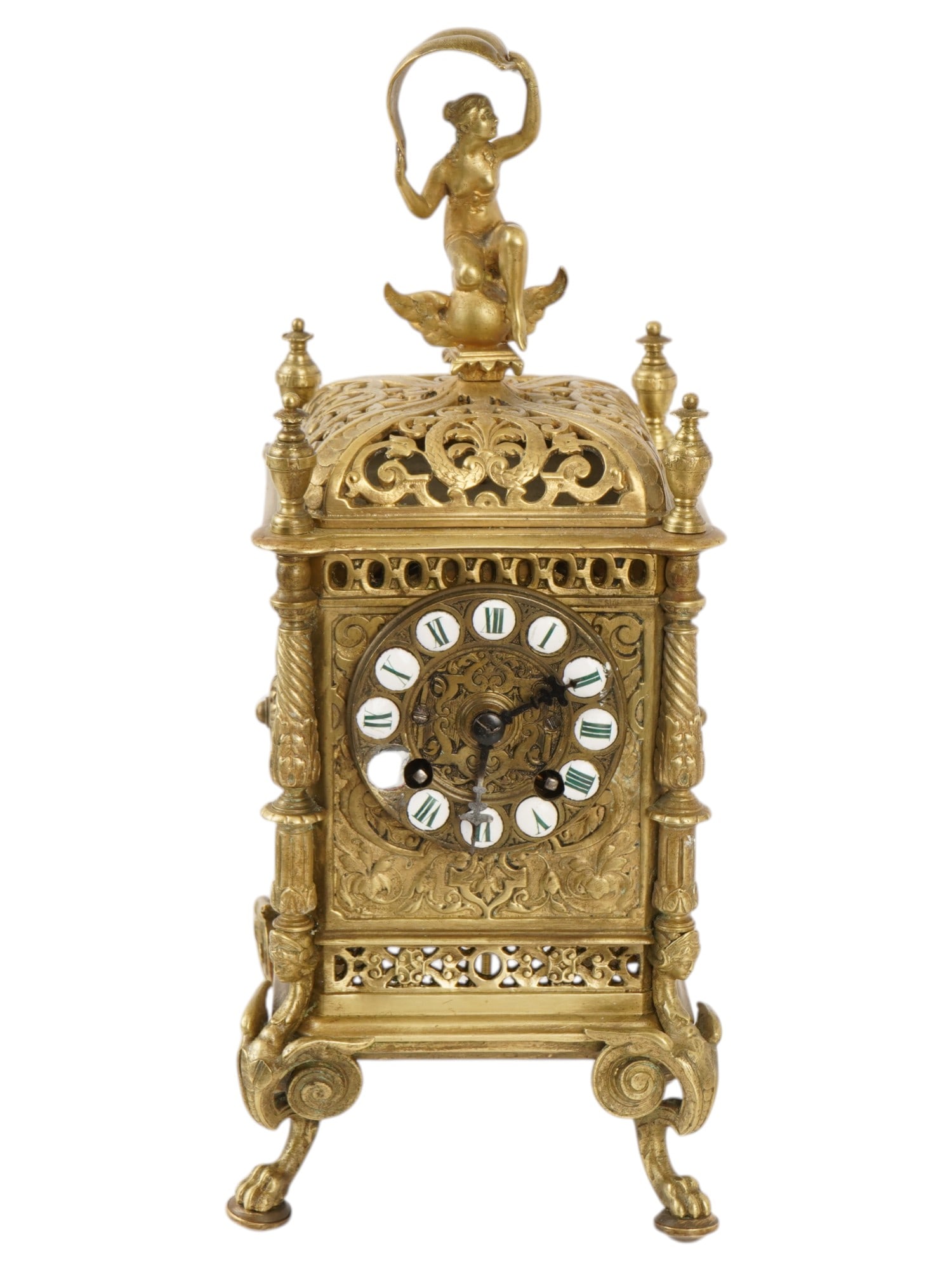 ANTIQUE EUROPEAN NAPOLEON III BRONZE TABLE CLOCK: An antique European bronze table clock in the Napoleon III style. The rectangular clock features a round dial with Roman numerals. It is richly decorated with a raised openwork pattern featuring