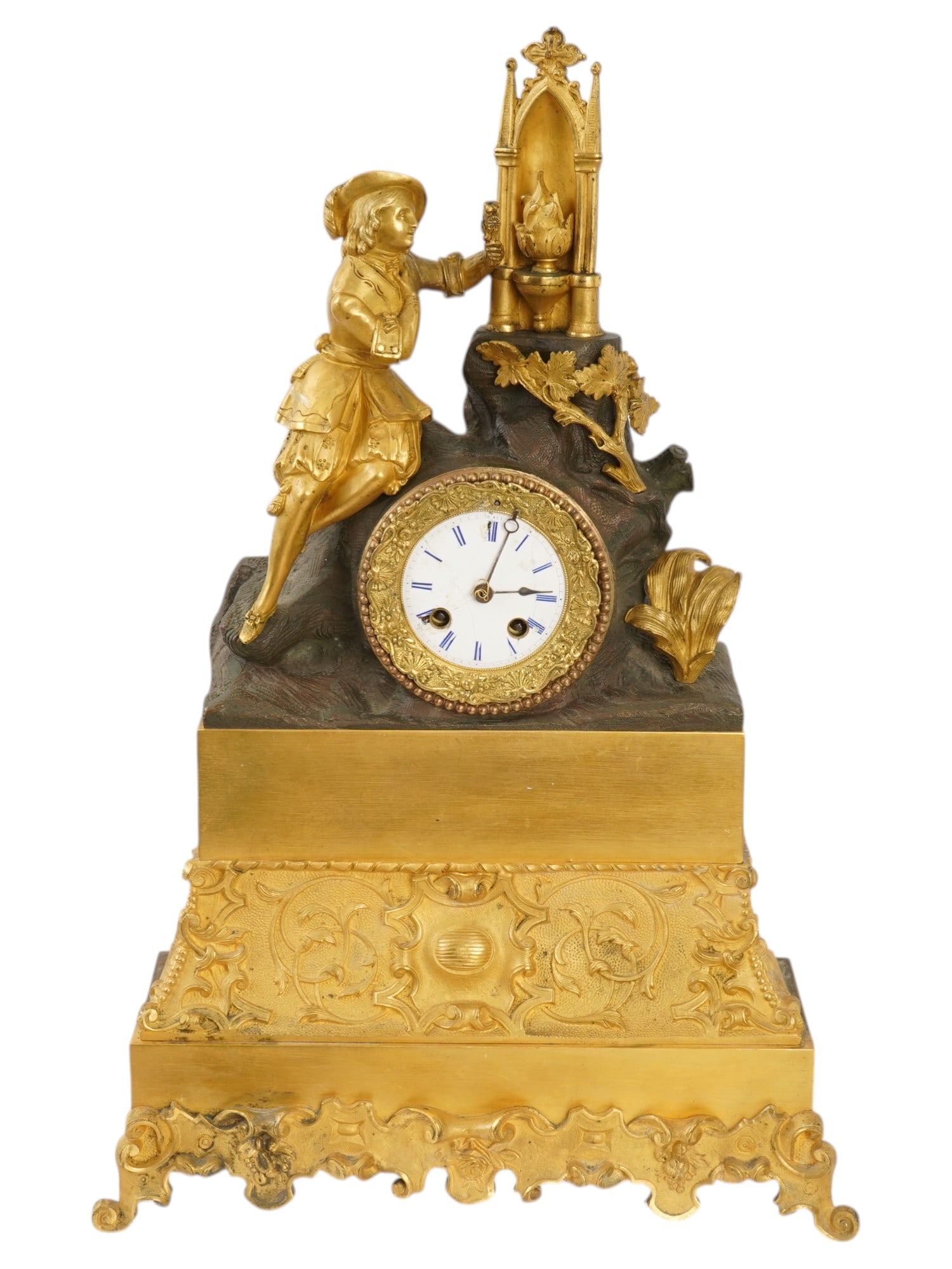 ANTIQUE FRENCH BRONZE AND BRASS MANTEL CLOCK: An antique French mantel clock. The clock is crafted from bronze and brass, featuring a multi-tiered construction. The top section features a finely detailed gilded figure, likely a young courtier or