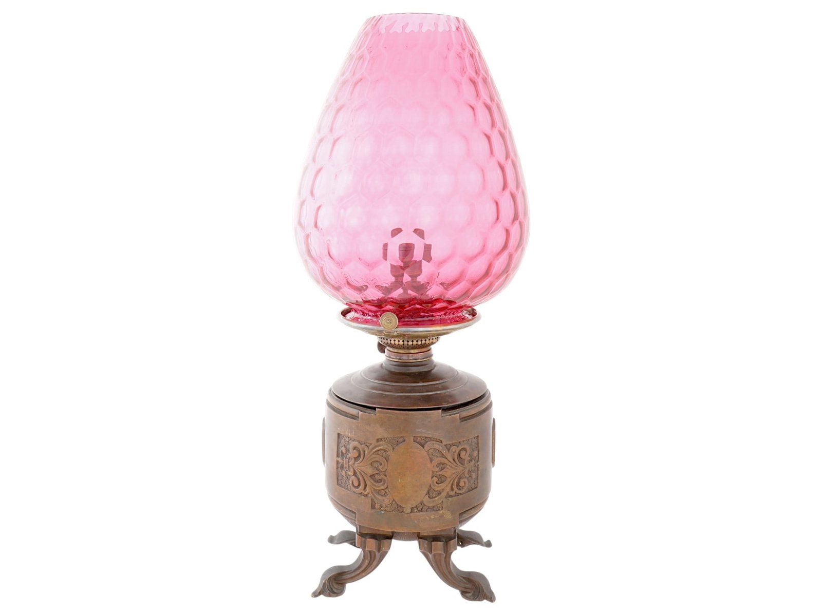 ORIGINAL ANTIQUE AMERICAN TIFFANY BRONZE GLASS OIL LAMP: An original antique American Tiffany and Co patinated bronze oil lamp that has been converted to electricity. The lamp features a distinctive art glass shade with a pink color and a textured pattern.