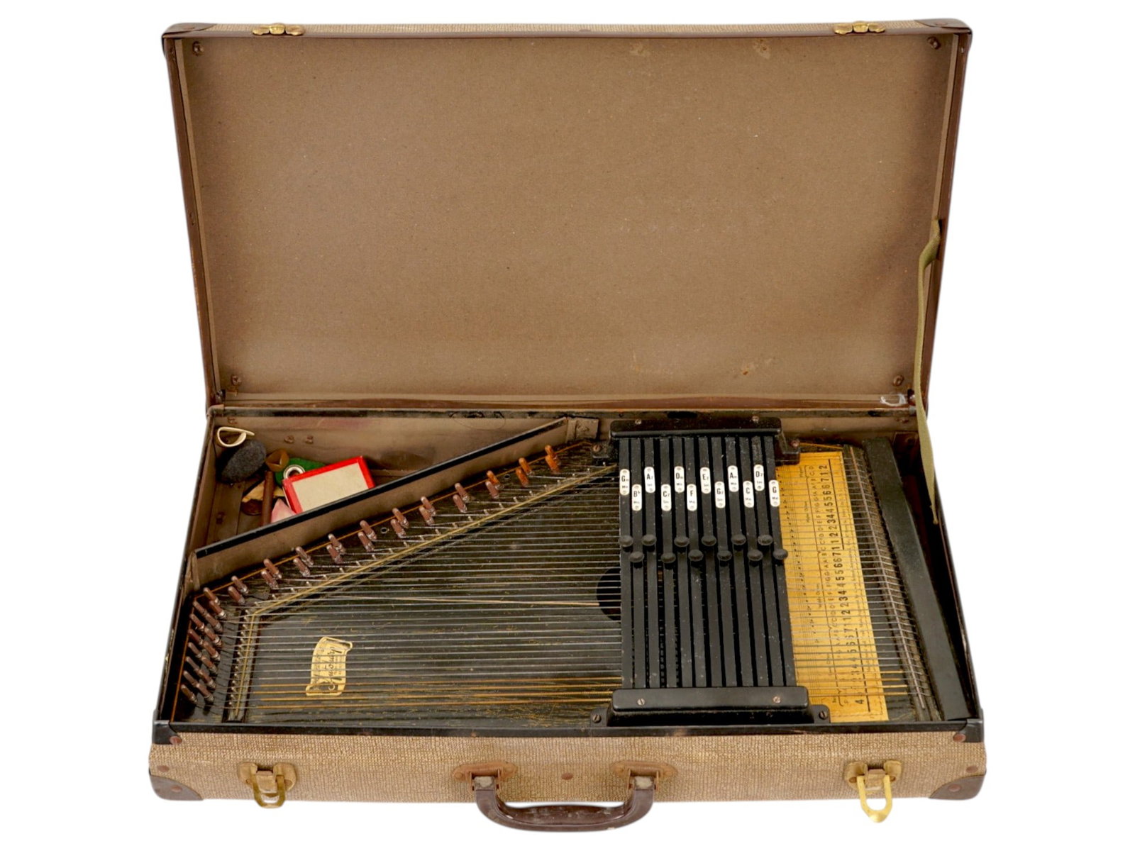 VINTAGE OSCAR SCHMIDT TWELVE CHORD AUTOHARP W BOX: A vintage Oscar Schmidt twelve-chord autoharp features a natural-finish wood soundboard adorned with a decorative rosette and the manufacturers label from Jersey City, New Jersey. The instrument is