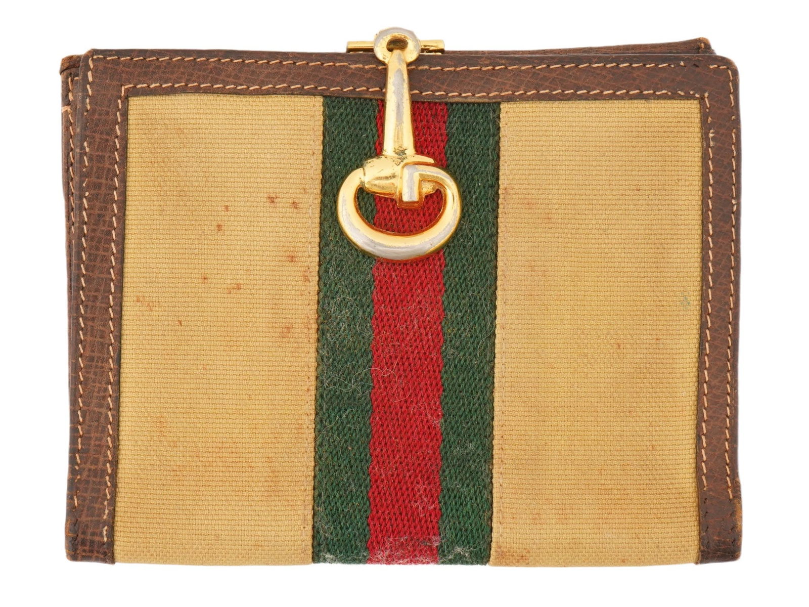 VINTAGE ITALIAN LEATHER AND FABRIC WALLET BY GUCCI: A vintage Italian leather and fabric wallet by Gucci. Circa 1950s to 1970s. The item features the rare Horsebit Clasp, an iconic stripe design, tan and green colors with brown leather trim. Gold tone 