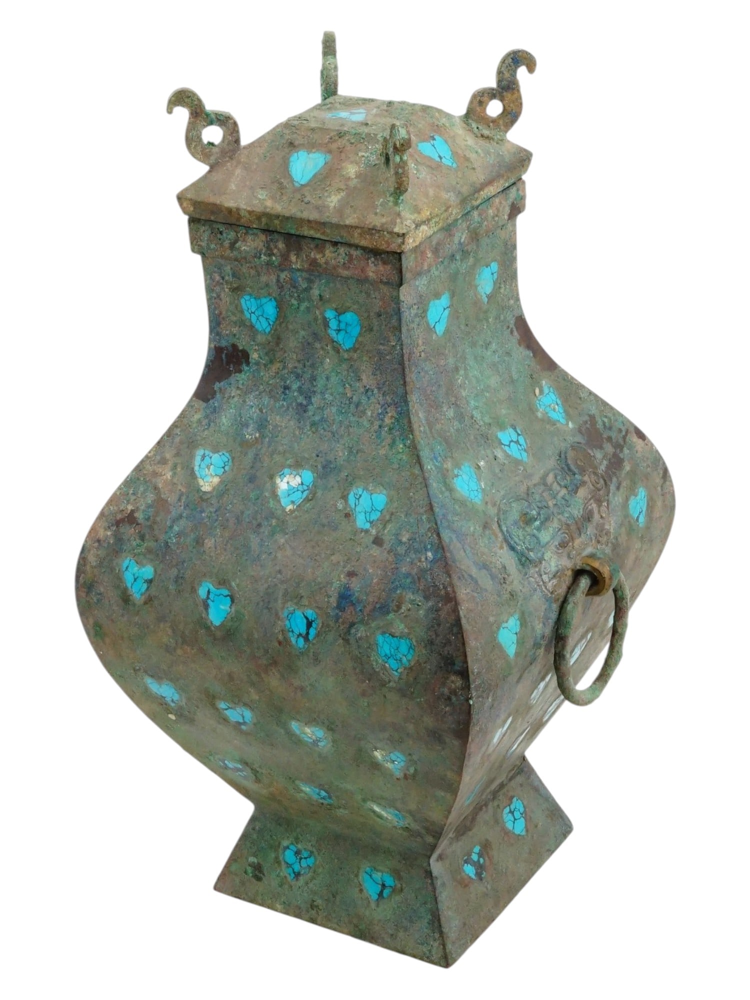 CHINESE HAN STYLE FANGHU BRONZE RITUAL VESSEL: A 20th-century Chinese cast bronze vessel, Fanghu. Han dynasty style. Square baluster shape, relief animal masks holding ring side handles, figurative finials on the lid. Heart-shaped turquoise orname