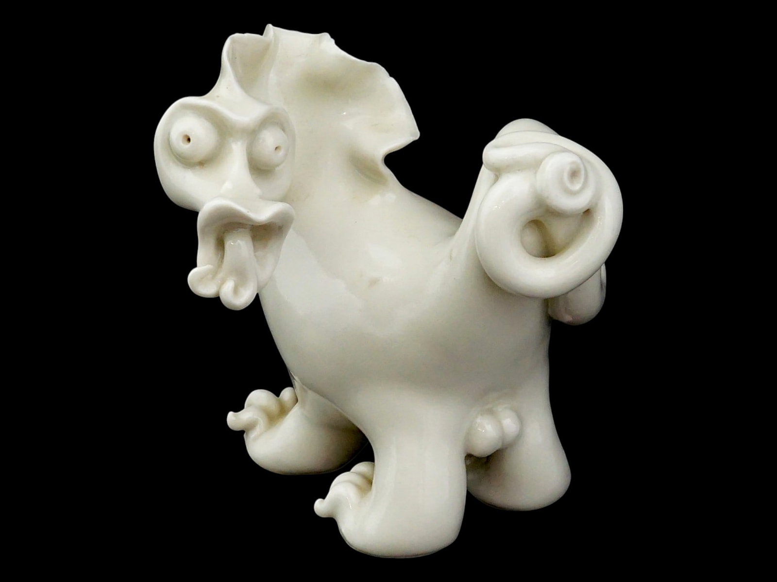 ANTIQUE CHINESE QING BLANC DE CHINE PORCELAIN FIGURE: An antique Chinese late Qing Dynasty Blanc de Chine porcelain figure depicting a whimsical mythical beast. Modeled with expressive features and decorative scrollwork, the figure is covered in a charac
