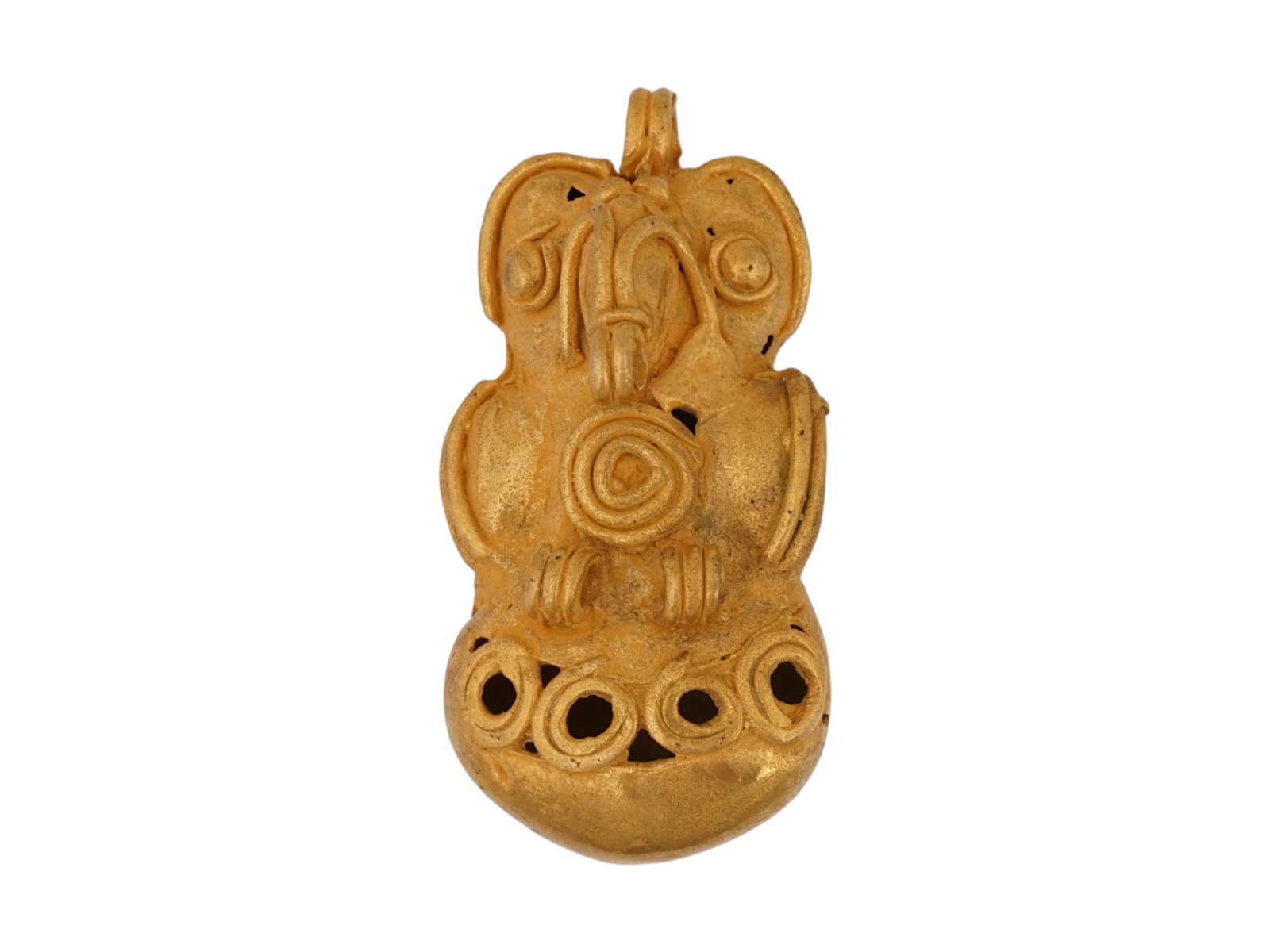 ANCIENT PRE COLUMBIAN TAIRONA TUMBAGA OWL FIGURINE: An ancient Pre Columbian Tairona Tumbaga figure or figural pendant representing an owl. A tumbaga, alloy of copper and gold, ornament, cast using the lost wax process, with its surface enriched by the