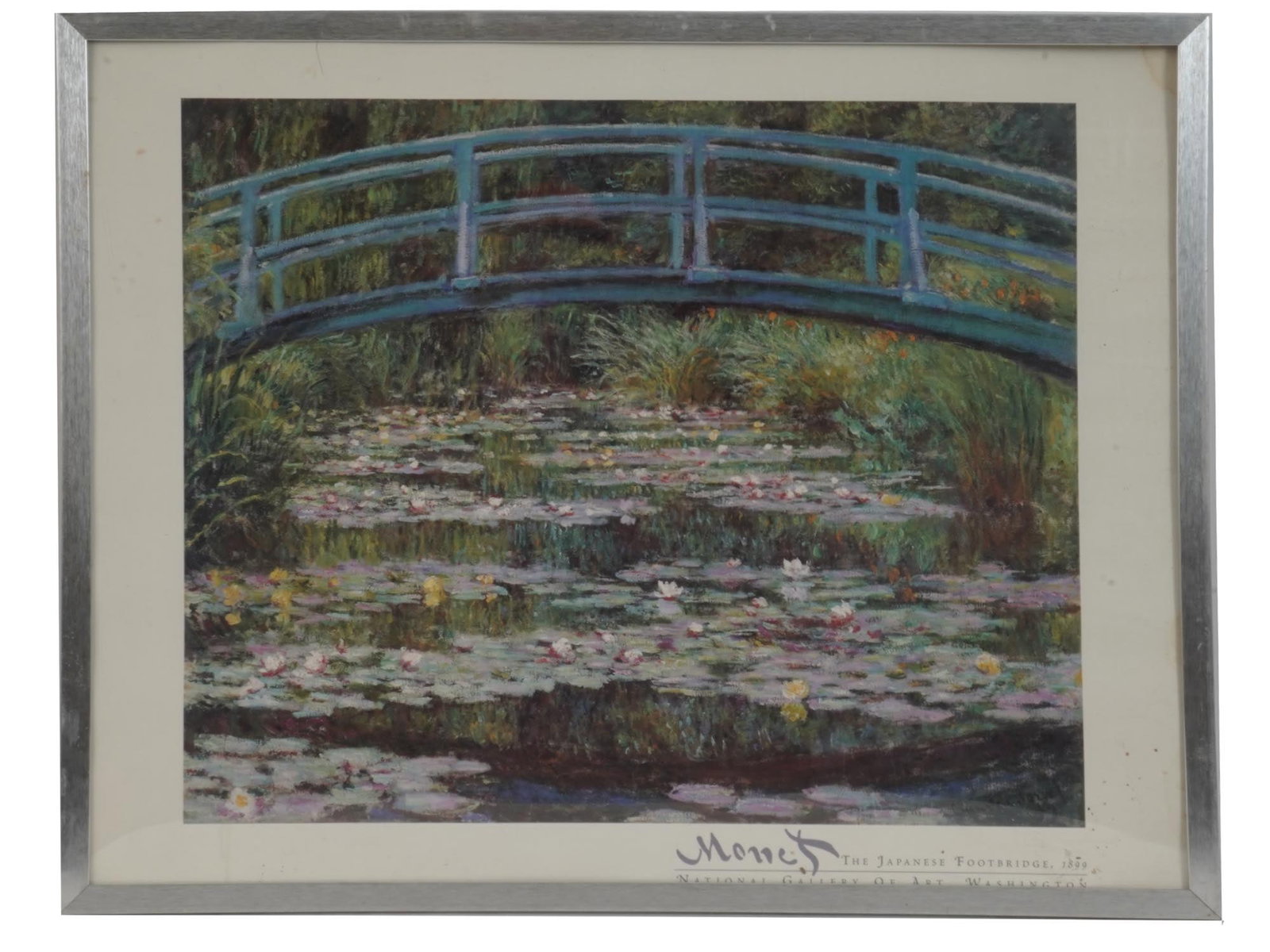 FRAMED WALL PRINT OF WATER LILIES BY CLAUDE MONET: A vintage poster, a reproduction of a 1899 artwork titled The Japanese Footbridge by Claude Monet, 1840–1926, a French Impressionist artist. The painting belongs to a large series of about 250 works