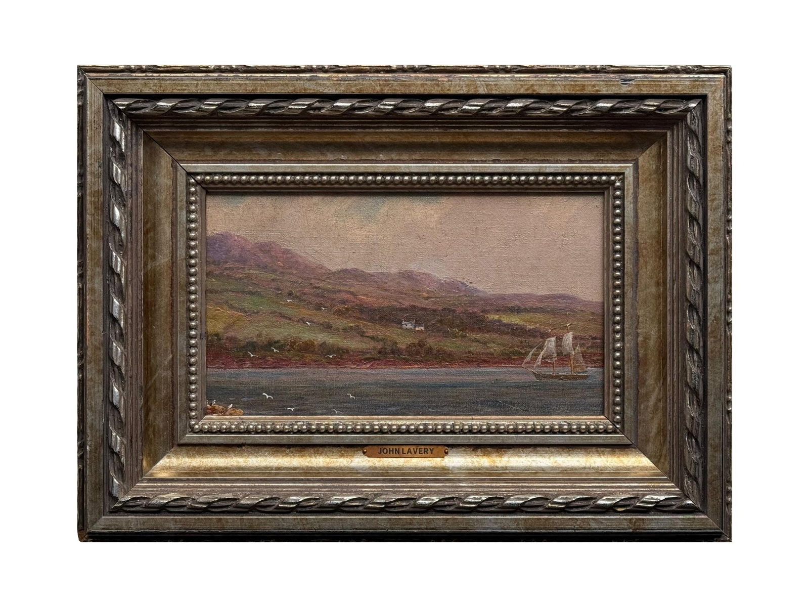 ANTIQUE EUROPEAN OIL PAINTING ATTR JOHN LAVERY: An antique European oil on board landscape painting attributed to Irish artist Sir John Lavery, 1856 to 1941. The painting depicts a coastal vista with undulating hills set against a calm body of wate
