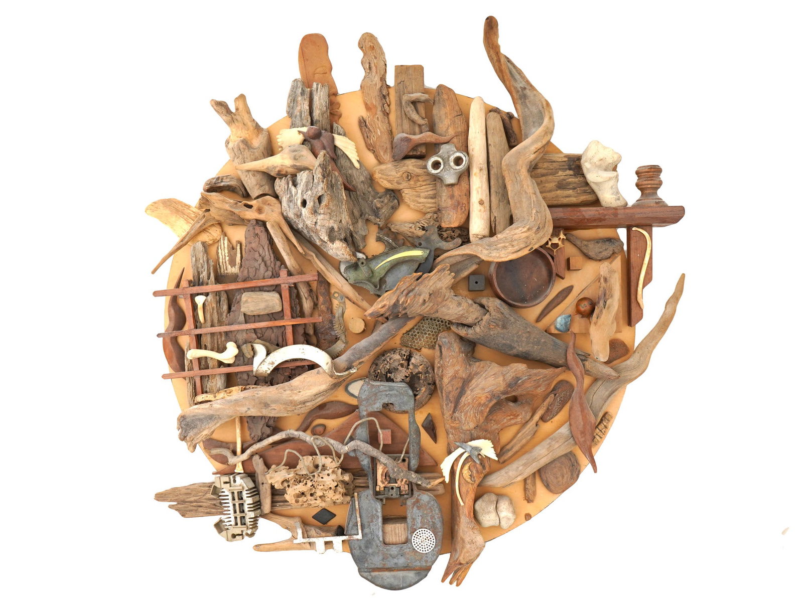 CONTEMPORARY WALL ART WOOD AND METAL SCULPTURE: A modern wall art sculpture composed of an eclectic arrangement of natural and carved wooden pieces, with metal elements, all mounted on a round base. The organic textures of the wood contrast with th