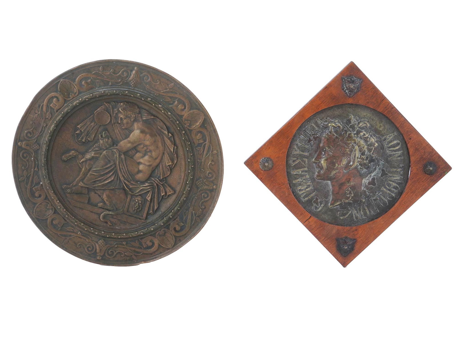 ANTIQUE BRONZE PLATE AND GREEK FEMALE RELIEF PLAQUE: An antique bronze plate in the aesthetics of Ancient Greek, depicting a scene of a man holding a cup with a tiger by his side. Accompanying this is a bronze plaque featuring a relief portrait of a wom