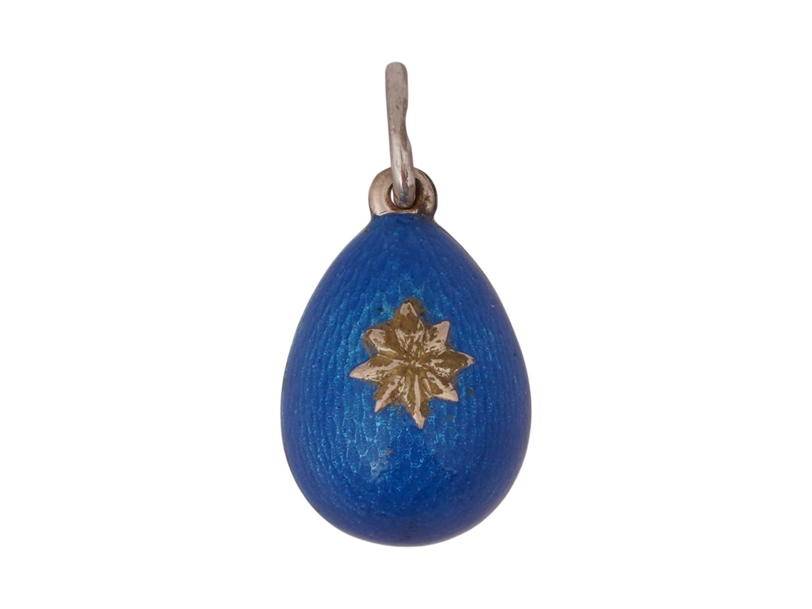 RUSSIAN SILVER GUILLOCHE ENAMEL EASTER EGG PENDANT: A Russian 88 Silver and enamel Easter egg pendant. The pendant is covered with a Guilloche enamel in a blue shade, and adorned with a relief design depicting a flower, on the front side. Marked with a