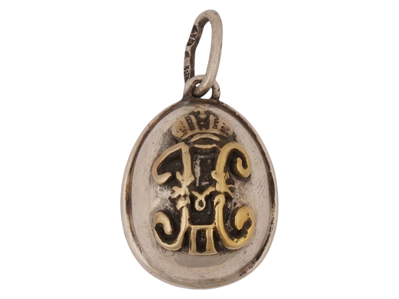 RUSSIAN IMPERIAL SILVER NICHOLAS II EASTER EGG PENDANT: A Russian Imperial silver Easter egg pendant featuring an applied gilt monogram of Tsar Nicholas II beneath the Imperial Crown on one side and the Russian double-headed Imperial eagle on the reverse. 