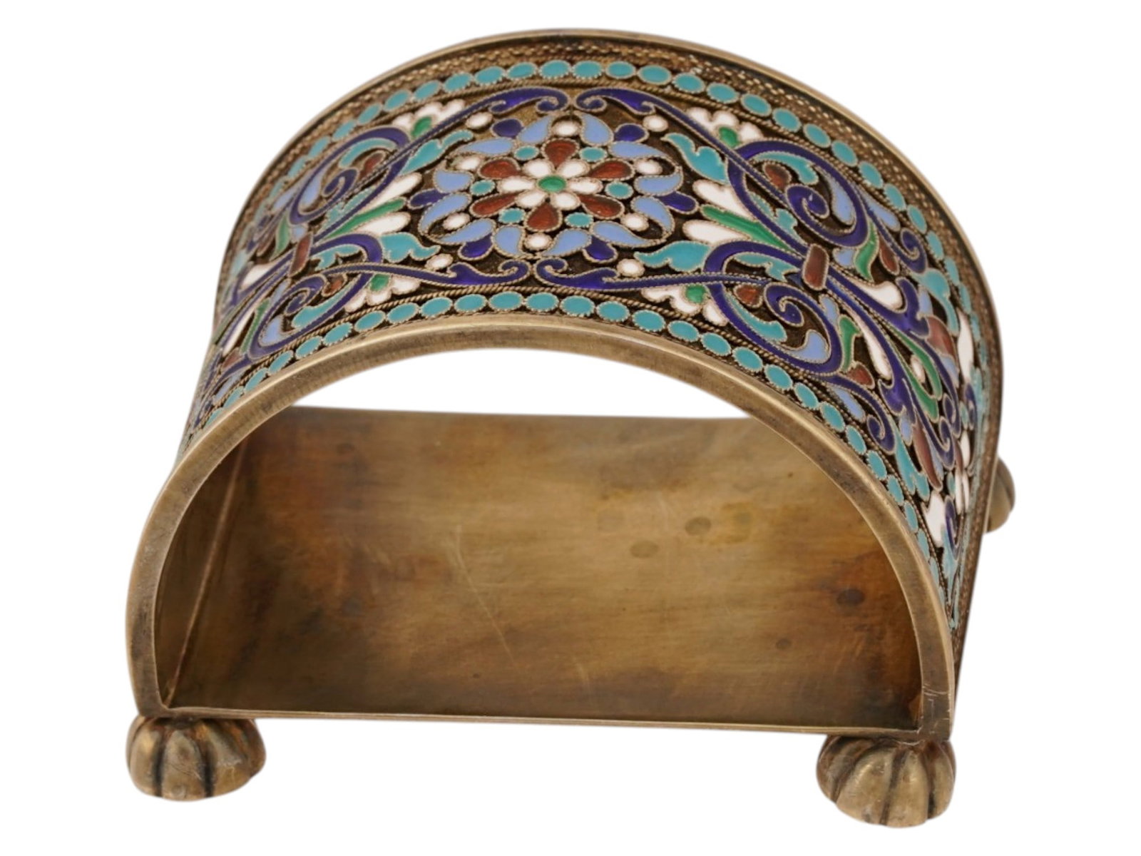 RUSSIAN SILVER AND CLOISONNE ENAMEL NAPKIN RING: A Russian footed Silver and enamel napkin ring. The exterior of the ware is adorned with a polychrome enamel design representing floral, foliage, and geometrical motifs made in the Cloisonne technique