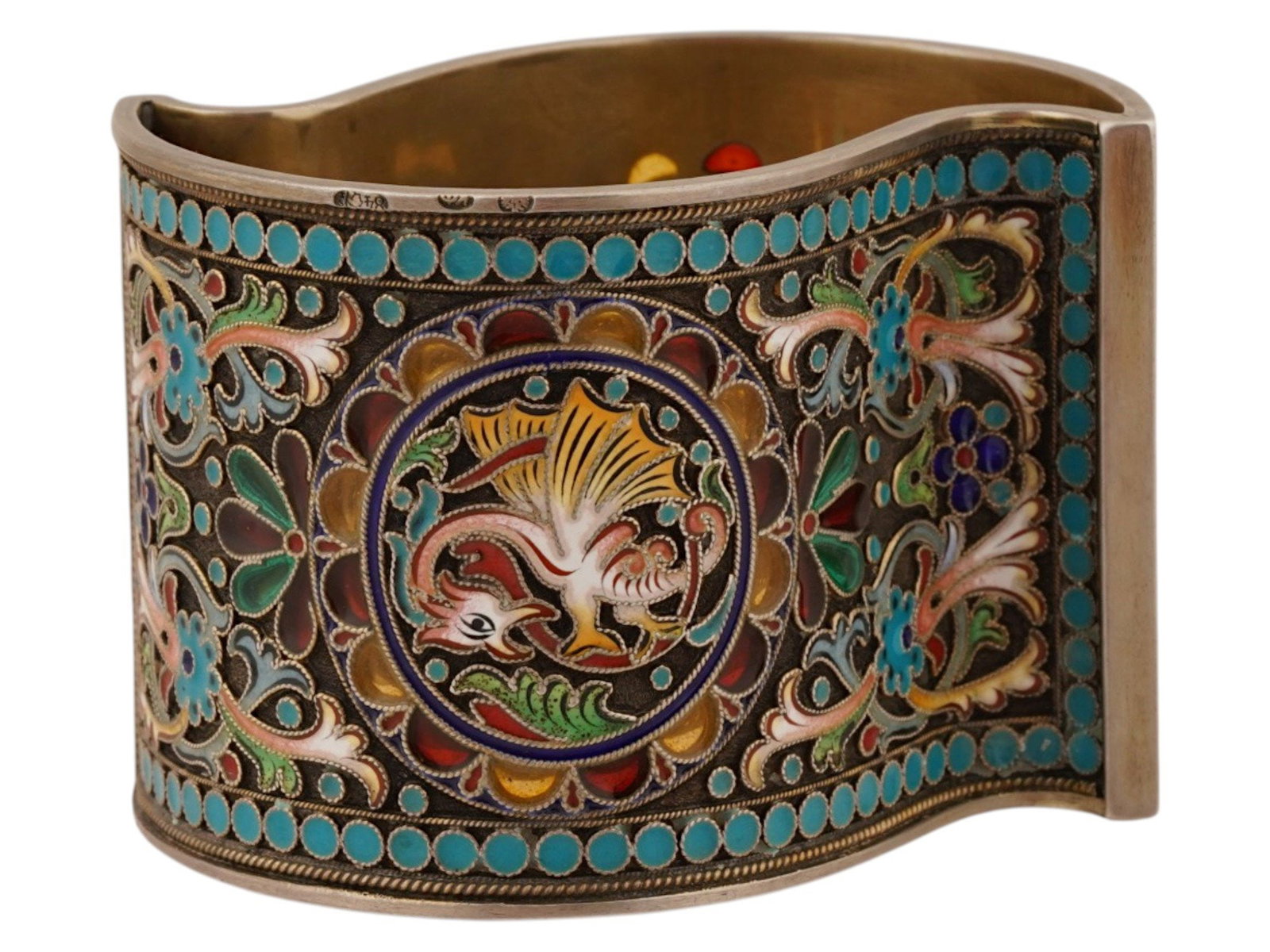 RUSSIAN SILVER PLIQUE A JOUR ENAMEL NAPKIN RING: A Russian gilt silver enamel napkin ring in the undulating cylindrical form enameled throughout with floral and foliage motifs with two dragon images on both sides in the beaded frame, produced in the