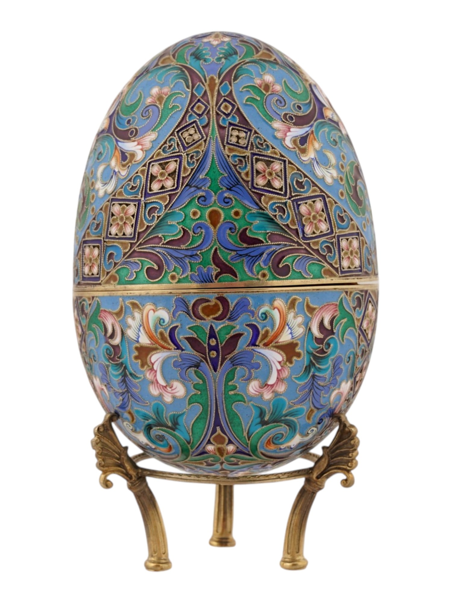 LARGE RUSSIAN SILVER ENAMEL EASTER EGG ON STAND: A large Russian silver Easter egg with a hinged two-part construction. The exterior is decorated with multicolored cloisonne enamel floral motifs. Raised on a distinctive gilt silver stand of three le