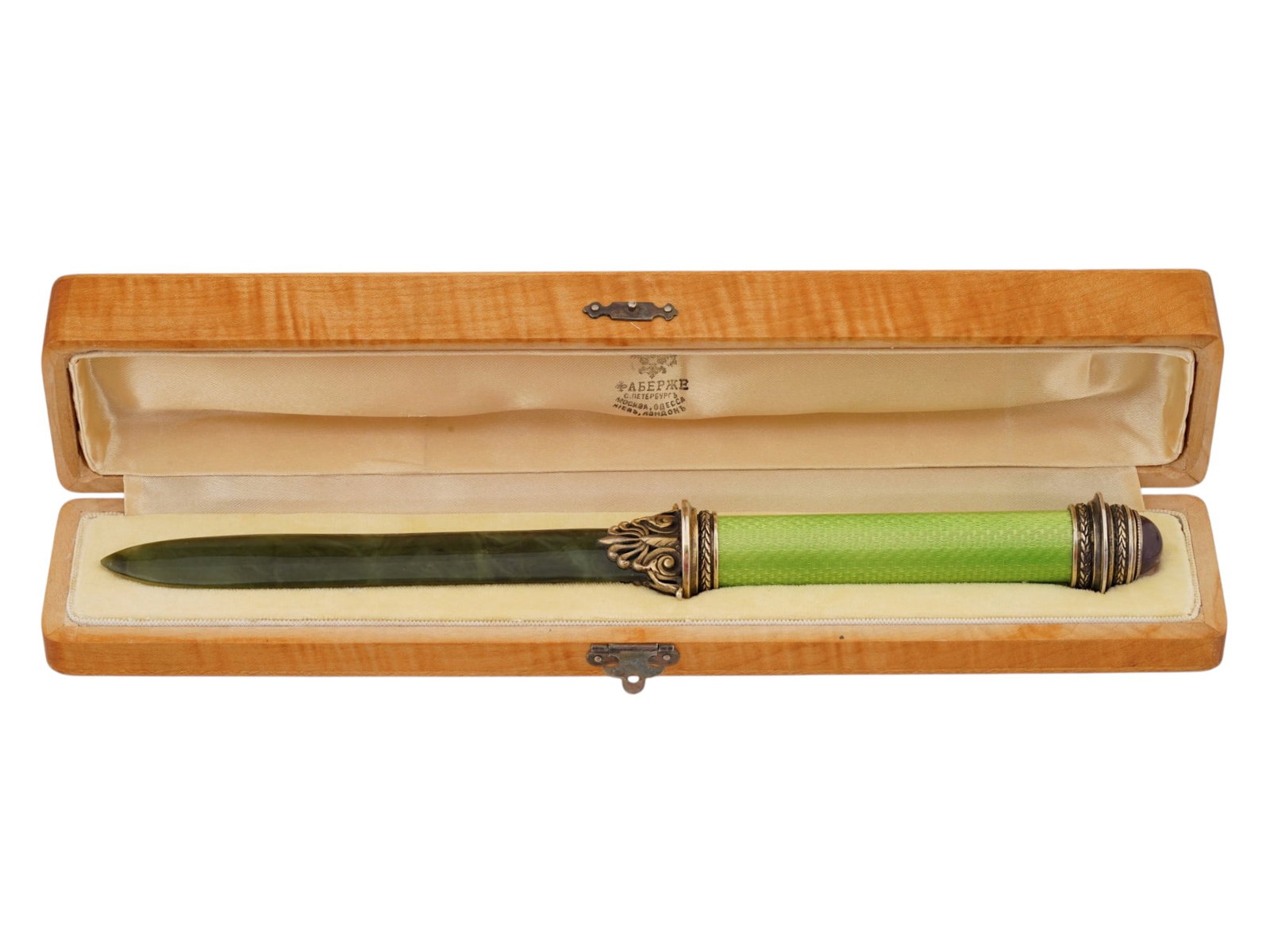 RUSSIAN SILVER NEPHRITE JADE ENAMEL LETTER OPENER: A Russian silver guilloche enamel letter opener with a carved nephrite jade blade. The handle is decorated with green guilloche enamel and gilt silver mounts accented by a cabochon amethyst finial. Pr