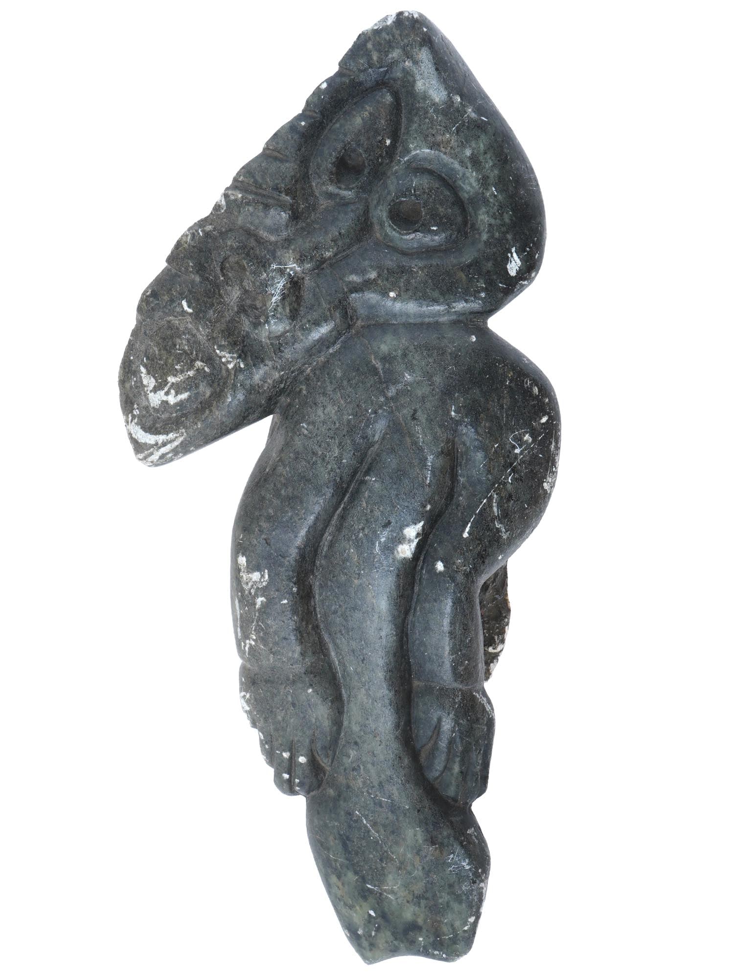 GREENLAND INUIT CARVED SOAP STONE TUPILAK SCULPTURE: A hand carved soap stone Inuit tupilak sculpture depicting a stylized human figure. Circa the mid 20th century. A tupilak is a monster or carving of a monster. In Inuit religion, especially in Greenla