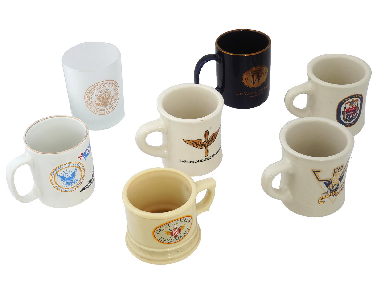 CERAMIC AND GLASS MILITARY AIR FORCE AND NAVY CUPS: A lot of 7 vintage ceramic and glass military cups. The lot includes mugs of different designs with Air Force and Navy symbols. American And English Military Drinkware Collectibles. THIS LOT IS ELIGIB