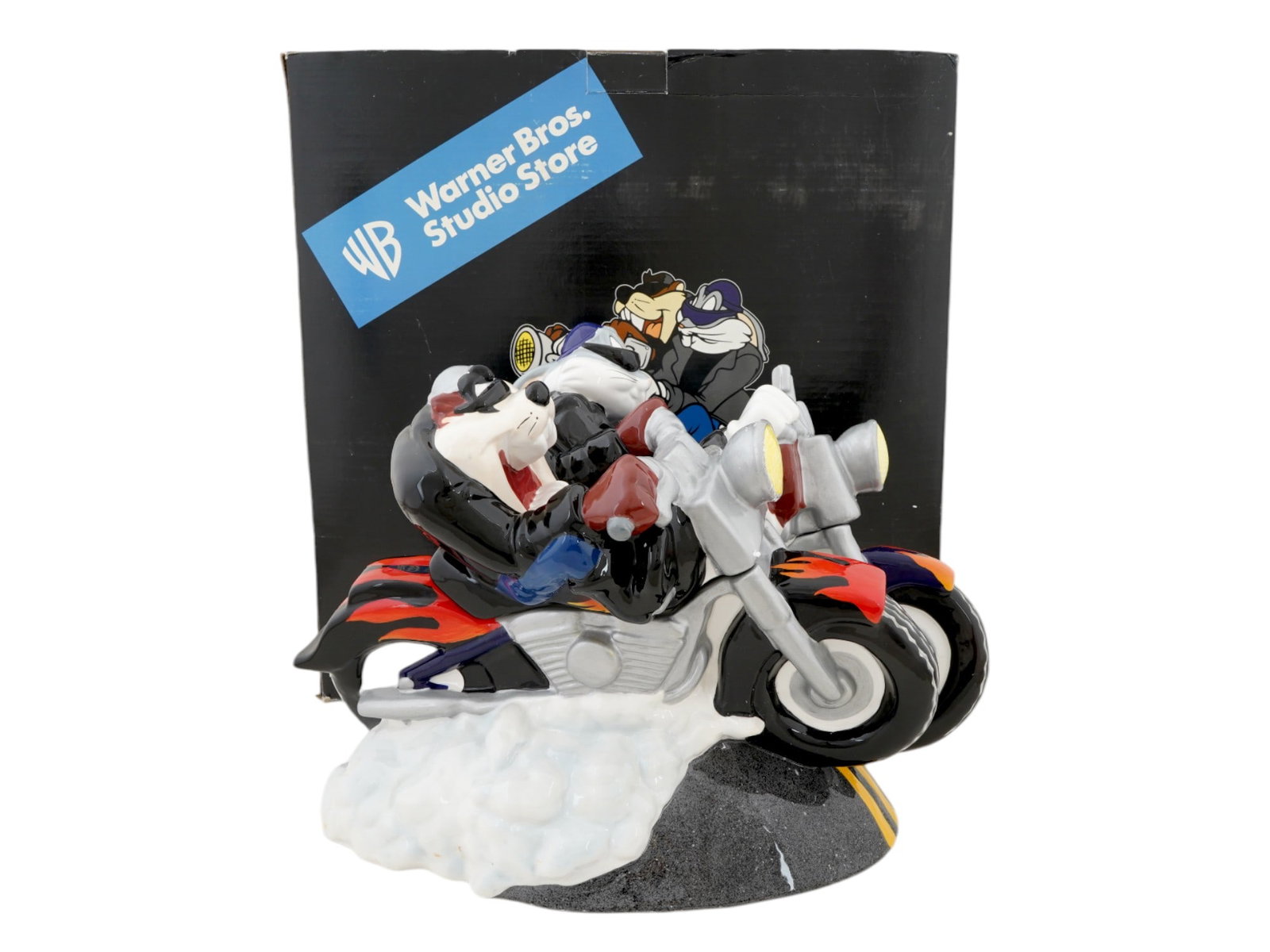US BUGS BUNNY TAZ CARTOON CERAMIC COOKIE JAR IOB: An American porcelain cookie jar from the Warner Bros. Studio Store. The jar is decorated with animated cartoon characters figurines, Bugs Bunny and Tasmanian Devil, Taz. Presented in an original box.