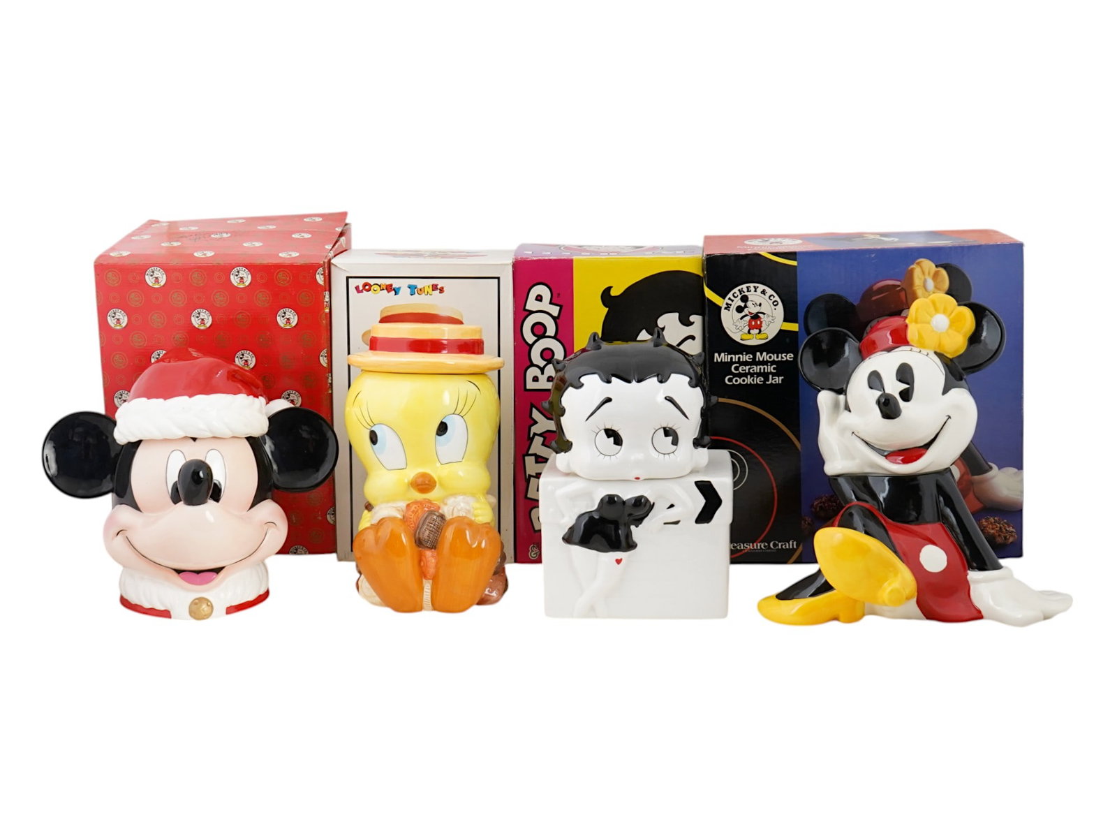 AMERICAN CARTOON CERAMIC COOKIE JARS IOB: A lot of four American Warner Bros, Benjamin and Medwin and Disney cartoon ceramic cookie jars, each in the shape of a character figurine: Looney Tunes, Betty Boop, Minnie Mouse and Mickey. Marked on 