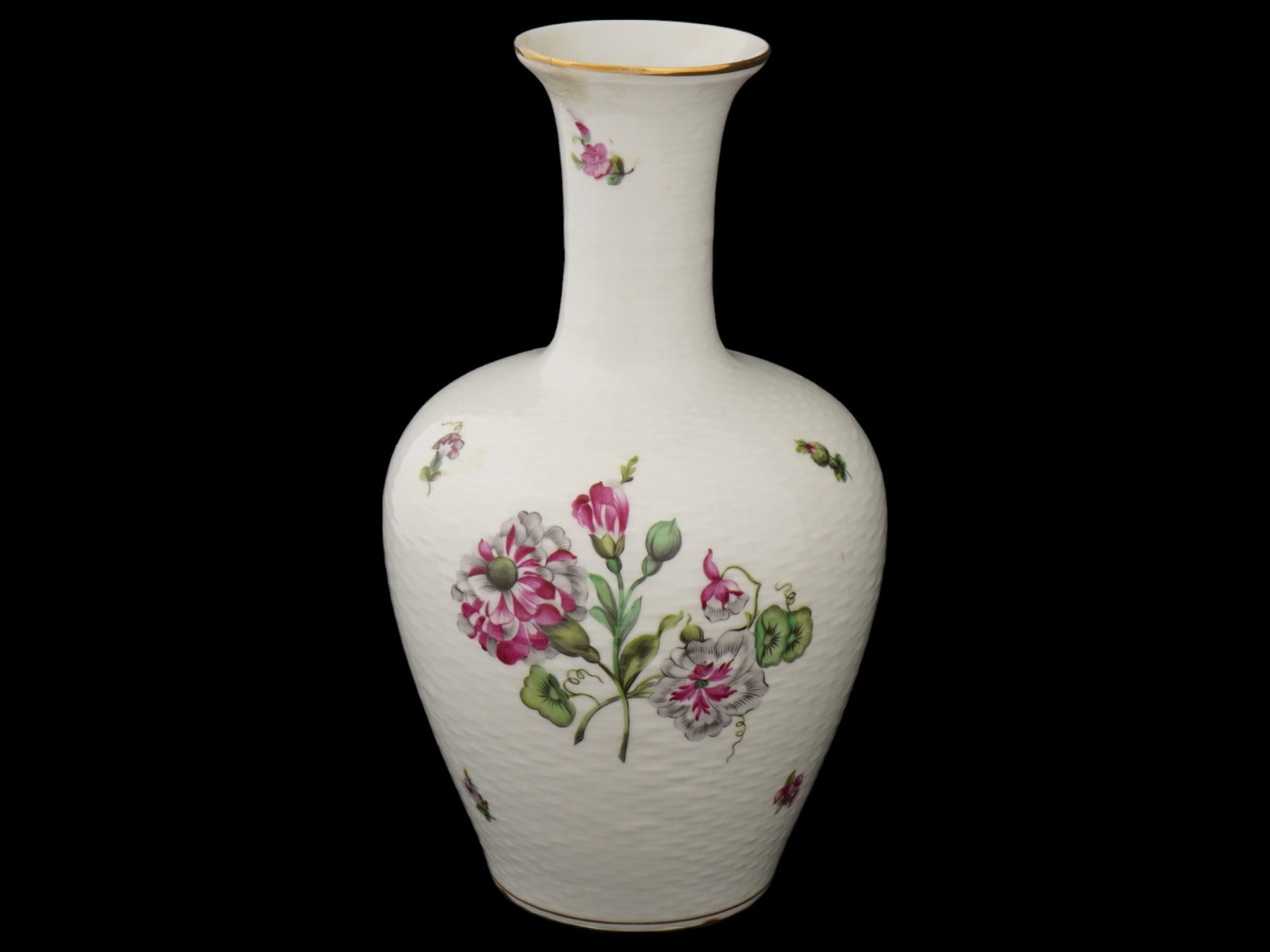 MID CENT HUNGARIAN HEREND PORCELAIN FLOWER VASE: A vintage white porcelain vase by Herend, a Hungarian porcelain manufacture active since 1839. Ca. 1950s. Baluster piece with elongated neck. Relief surface. Polychrome transfer-printed flower motifs.