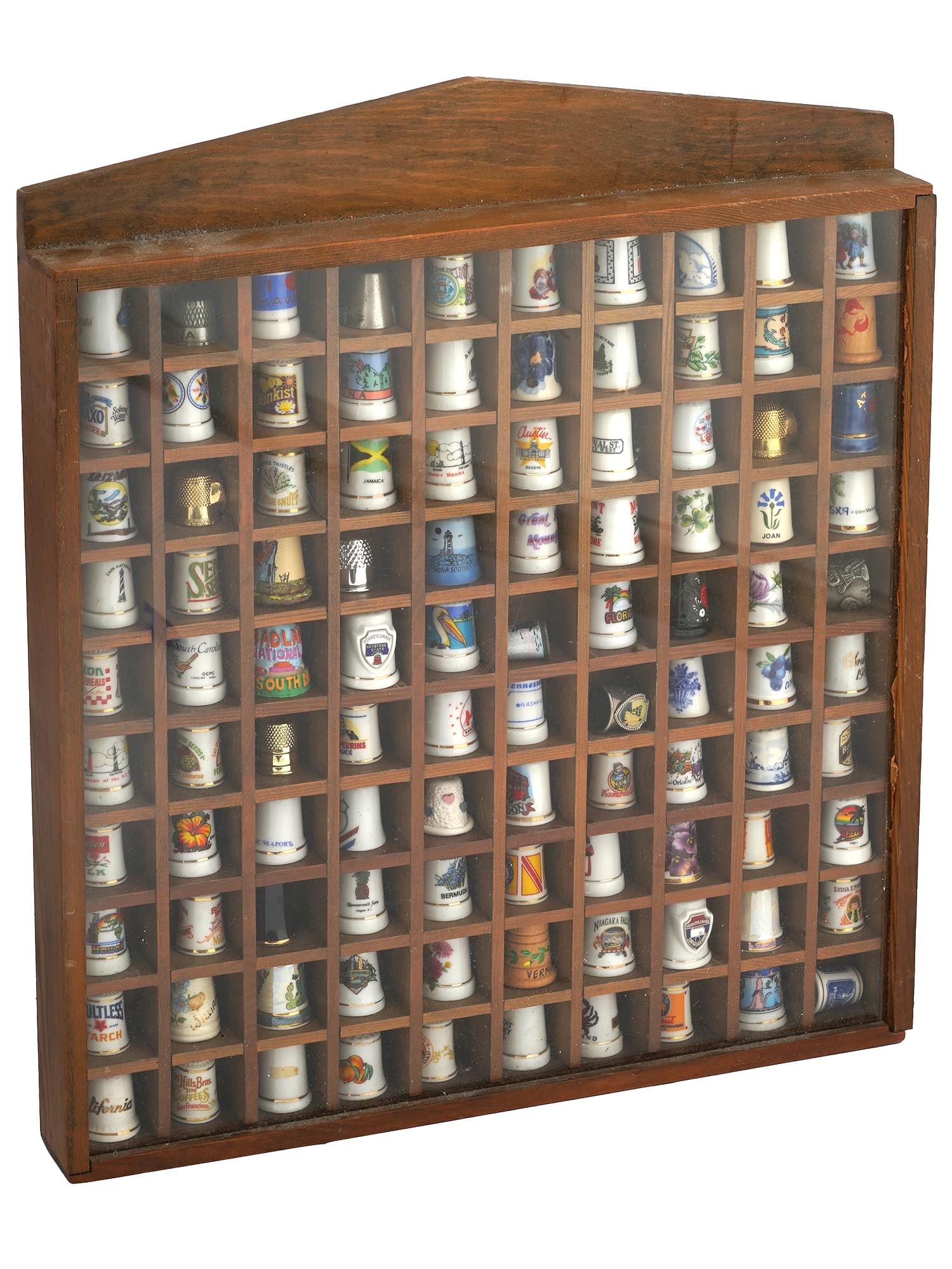 PORCELAIN AND METAL THIMBLES IN WOODEN CASE: A large collection of vintage porcelain and metal thimbles in a wooden case. The case contains 100 items total. Each thimble has a different design and is made by different manufacturers, including Am