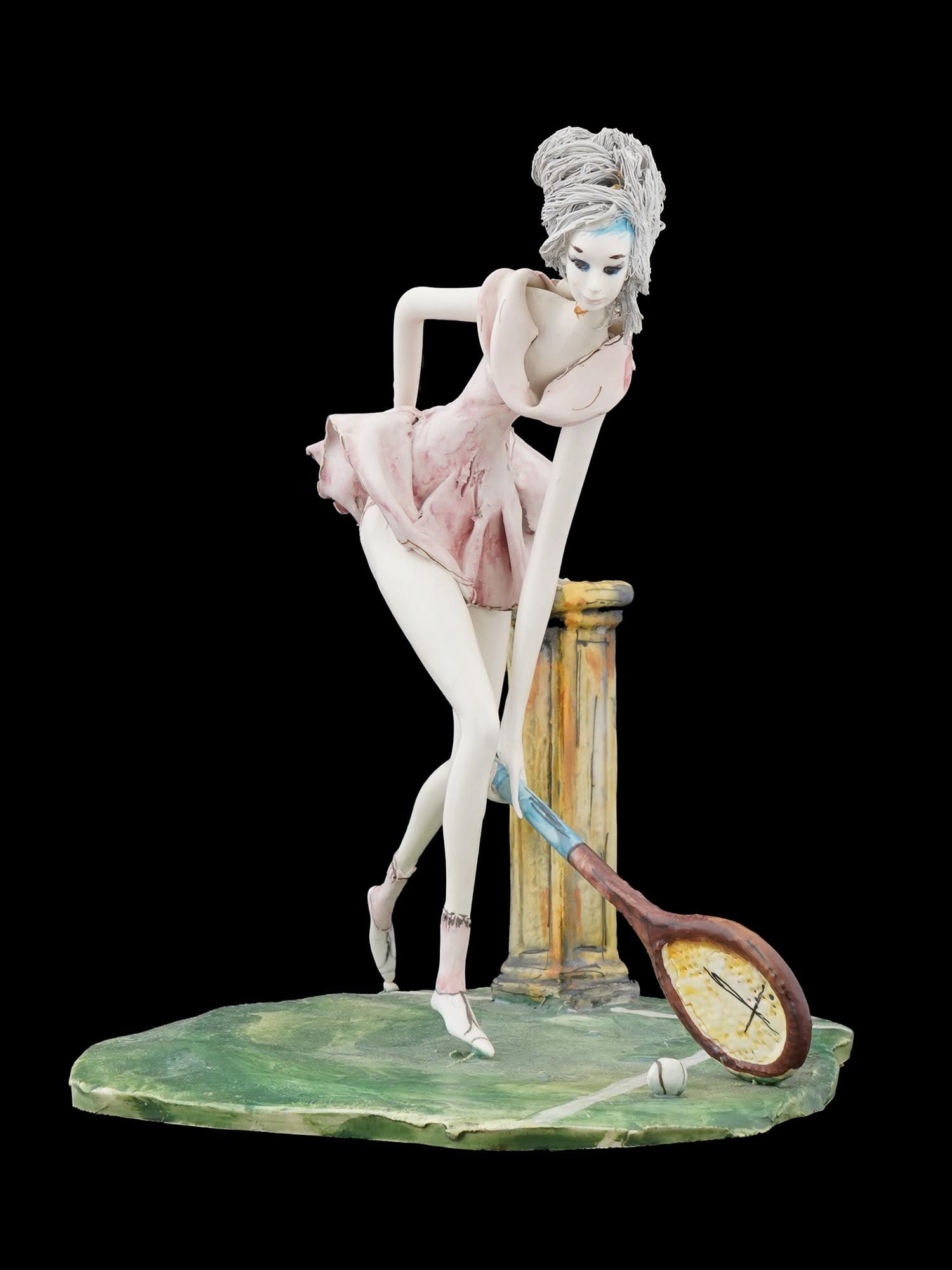 MODERNIST PAINTED PORCELAIN FIGURE OF TENNIS GIRL: A Modernist hand painted porcelain figure representing a girl playing tennis. Mounted on a figural base. Inscribed, probably Gauso, on the base. Numbered under the base. Modernist and Contemporary Por