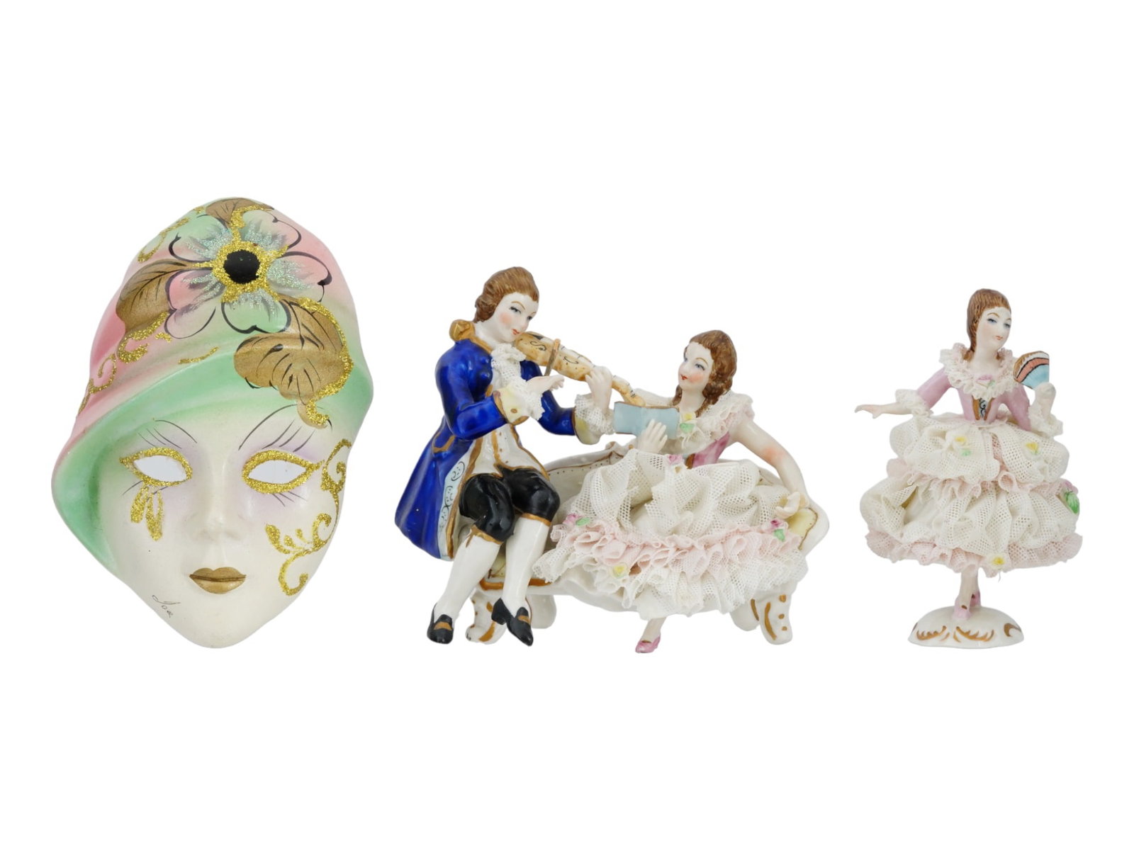 IRISH DRESDEN LACE PORCELAIN FIGURINES AND MASK: A pair of mid-20th century hand-painted porcelain figurines with lace decor and gilt accents by Muller Volkstedt. The first represents a woman with a fan, model 1066. The second depicts a Rococo galan