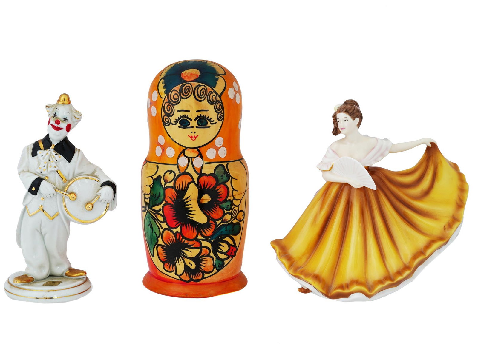 TWO PORCELAIN FIGURINES AND WOODEN MATRYOSHKA: A group of three figurines includes two exquisite porcelain figures and a Russian hand painted wooden Matryoshka doll, showcasing the artistry and cultural heritage of decorative craftsmanship. The Vi