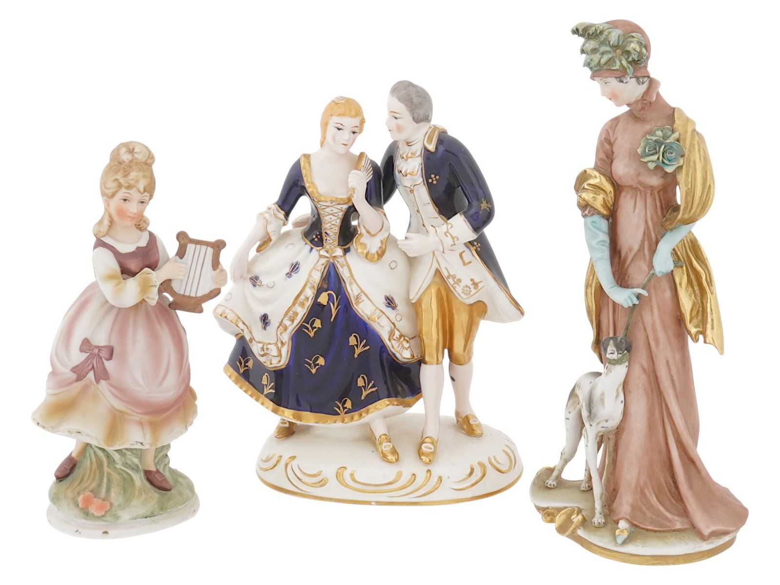 LOT OF VINTAGE EARLY 1950S PORCELAIN CHILD FIGURINES: A lot of three vintage early 1950s ceramic child figurines. The first figure is a red haired boy with a violin, raising his hat. There is a manufacturers label at the bottom, Ucagco Ceramics Japan. Th