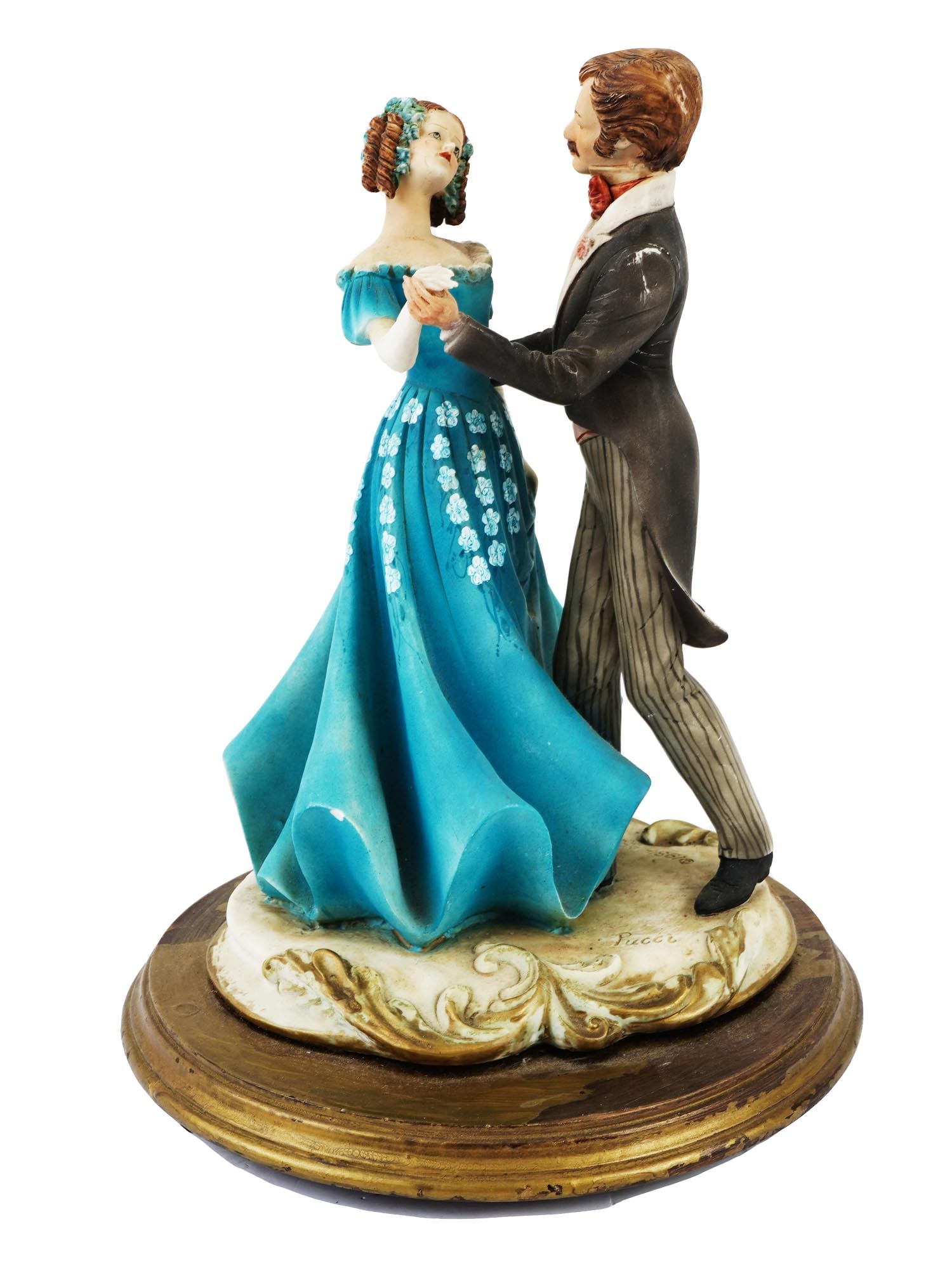 1984 PUCCI ARNART COUPLE COMPOSITE MUSICAL STATUE: A 1984 Pucci Arnart Leonora Verdi composite musical statue captures a romantic dance between a dressed couple. The statue features a gentleman in a classic black tuxedo with a bow tie, and a lady in a