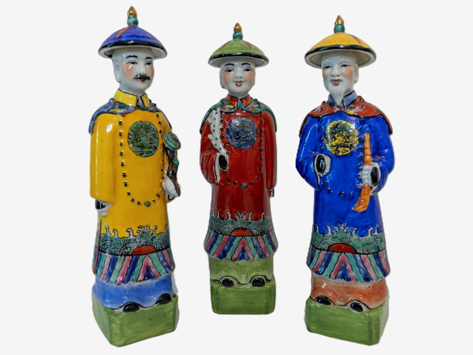 THREE PORCELAIN QING EMPEROR FIGURES WITH MAKERS MARKS: Set of Three Chinese Porcelain Mandarin Figures (Officials)Late Qing dynasty, most plausibly Guangxu period (1875–1908).These figures represent civil officials (Mandarins) in formal court dress, dis