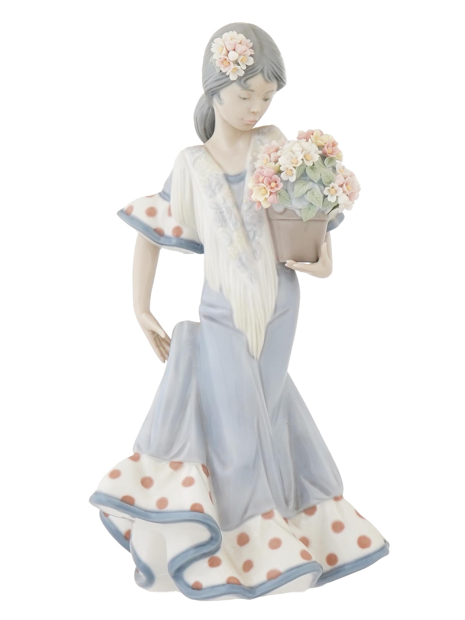 VINTAGE LLADRO PORCELAIN FIGURINE FLOR MARIA IOB: A vintage glazed porcelain figurine by Lladro, a Spanish porcelain manufacture. The figure represents a girl with a flower pot. Titled Flor Maria. Model no. 5490, designed by Juan Huerta. Hallmark Lla