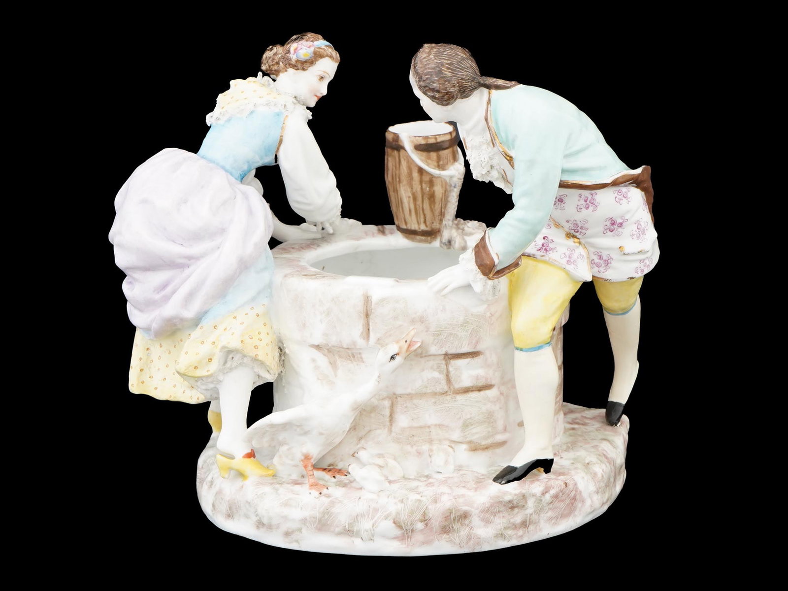ANTIQUE EUROPEAN PORCELAIN CACHEPOT W FIGURAL GROUP: An antique European porcelain cachepot with a figural group. The item is sculpted with two lovers chasing each other around a well. Unmarked. Presumably of German origin. Antique and Vintage European 
