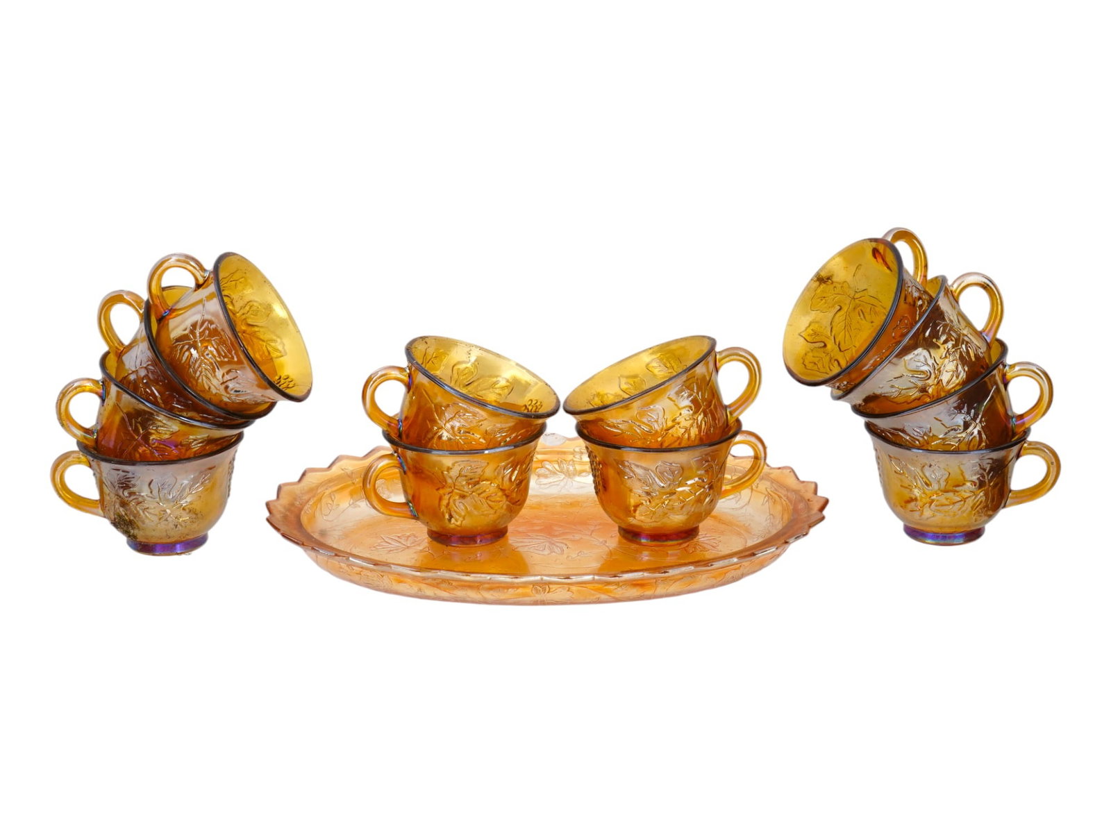 MID CENT INDIANA HARVEST AMBER CARNIVAL GLASS SET: A set of mid-20th century American pressed glassware by Indiana Glass Company. Ca. 1970s. A total of 13 items, including 12 tea cups and a serving tray. Harvest collection in iridescent amber color. R