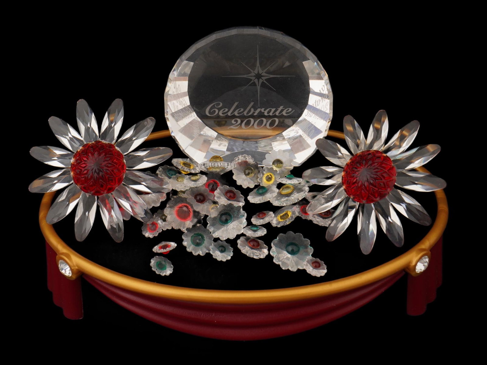 LOT SWAROVSKI CRYSTALS SCS DAISY PAPERWEIGHT STAND IOB: A collection of Swarovski crystal wares. The lot includes two Swarovski crystal Red Marguerite Daisy figurines that was a gift for Swarovski Collectors Society SCS members who renewed their membership