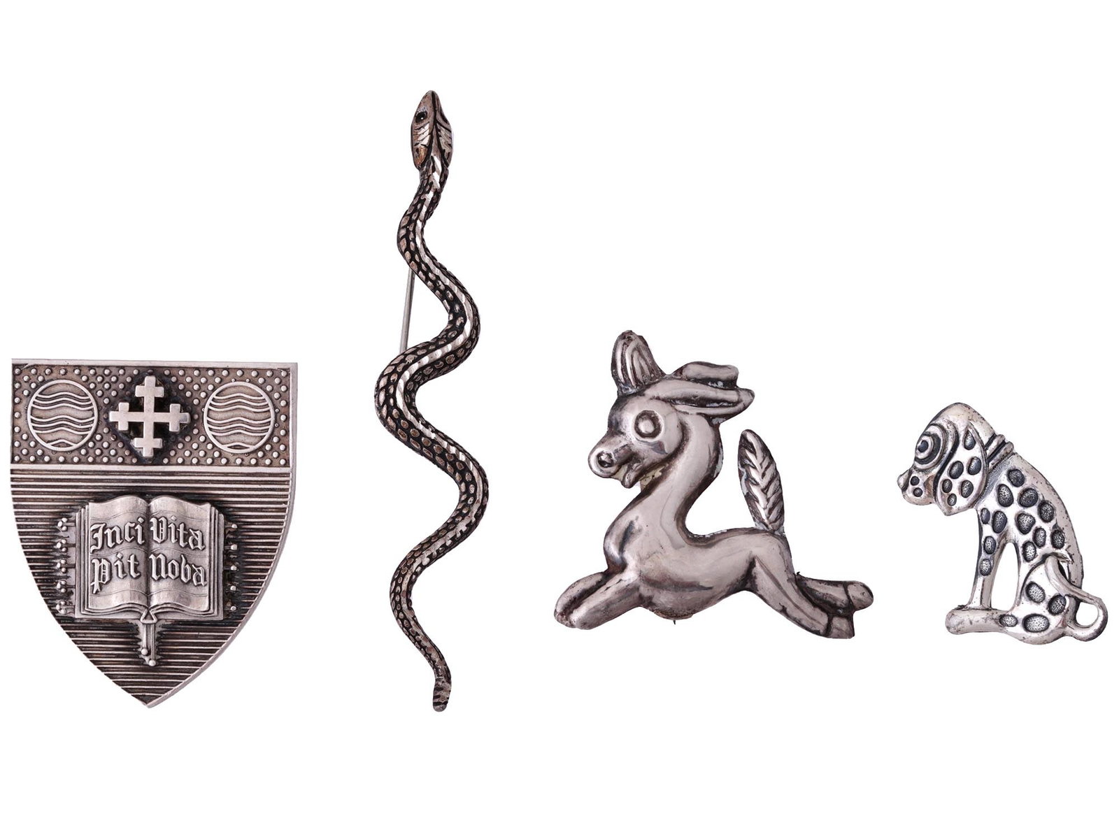 VINTAGE STERLING SILVER BROOCH COLLECTION: A collection of four vintage sterling silver brooches presents an array of charming and meaningful designs. The first brooch showcases a sleek and sinuous snake, representing transformation and renewa
