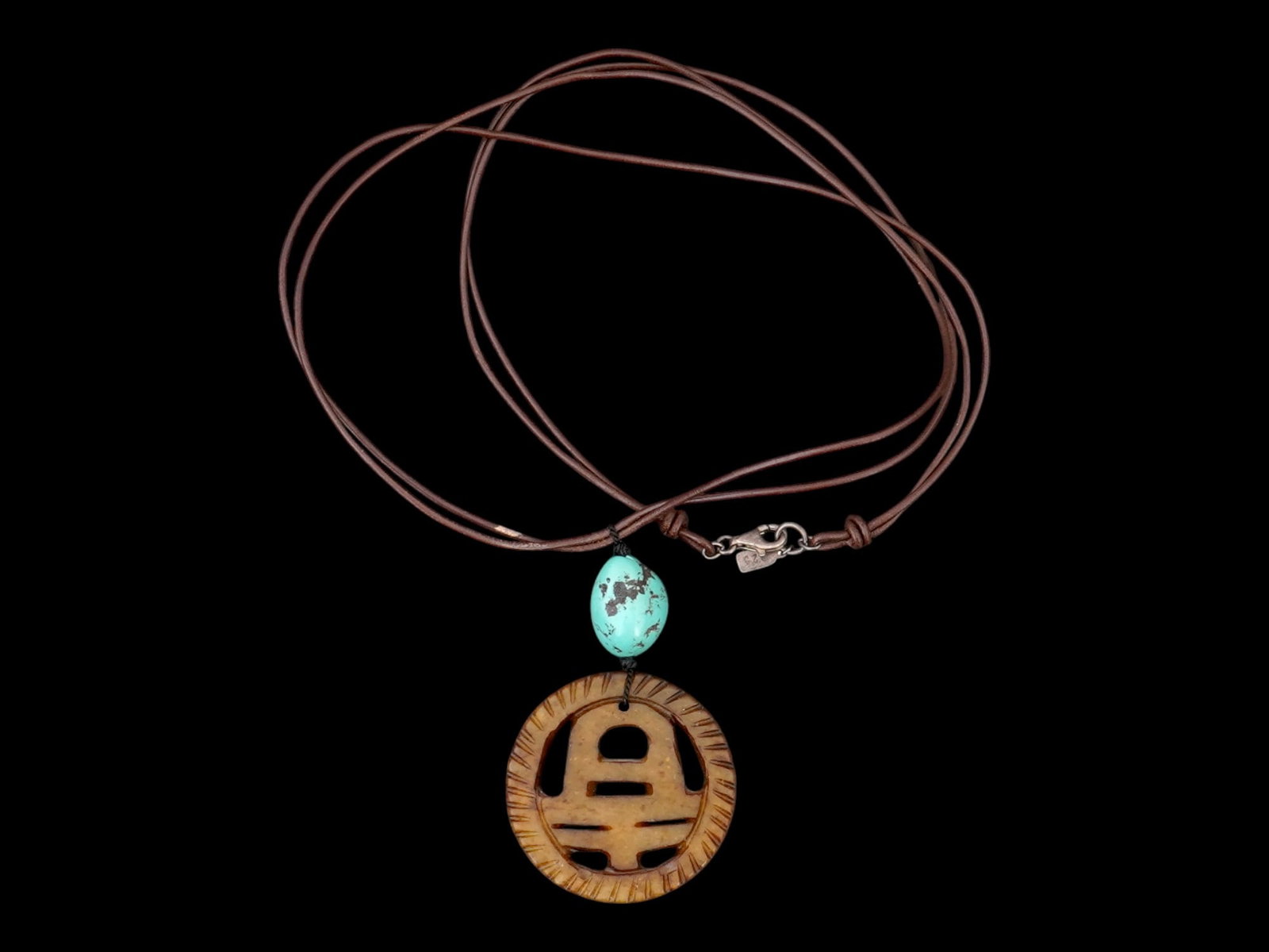 VINTAGE CHINESE NECKLACE WITH A PENDANT AND A BEAD: A vintage Chinese necklace featuring a metal pendant styled like a traditional Chinese cash coin, with a circular form. The pendant is accented with a bead. Combining natural materials with meaningful