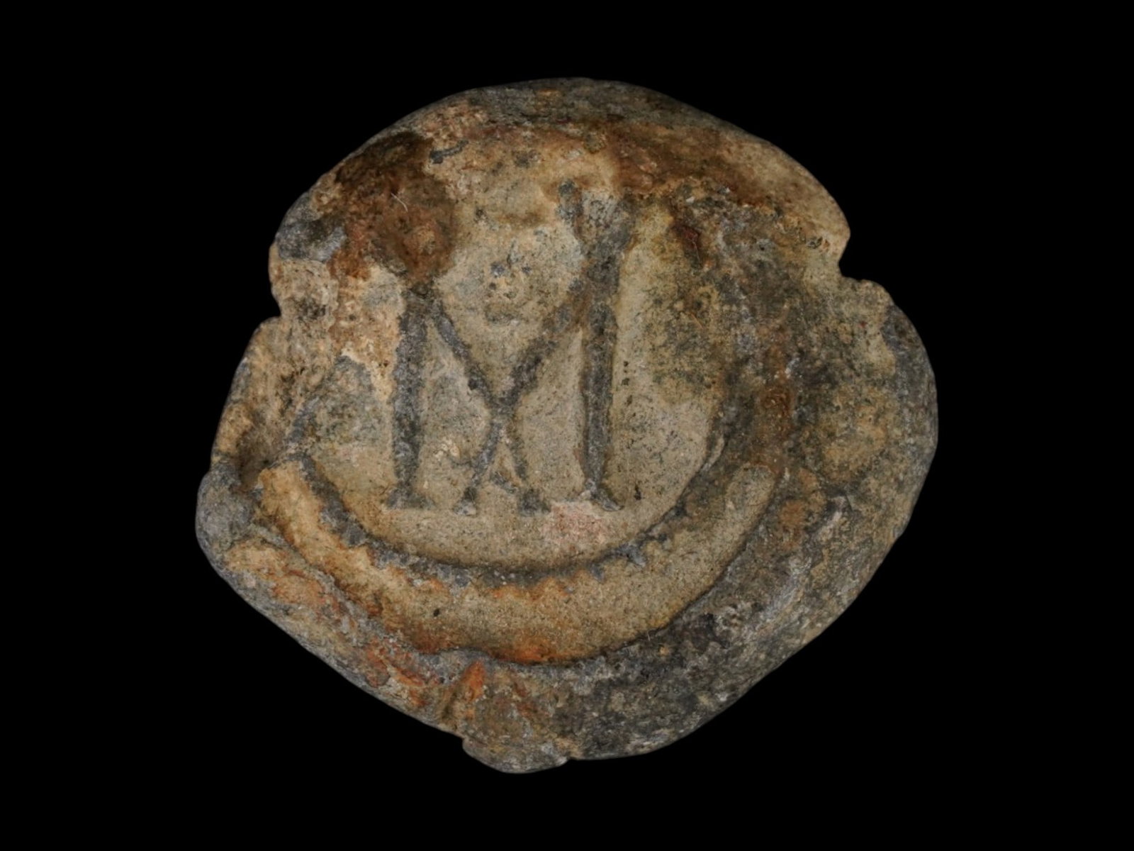 ANCIENT BYZANTINE LEAD STAMP SEAL W LETTER M AND CROSS: An ancient Byzantine lead stamp seal, dating to approximately 400 to 600 AD. The piece is marked with the letter M and a cross motif, possibly indicating its use as a seal for a wine vessel or commerc