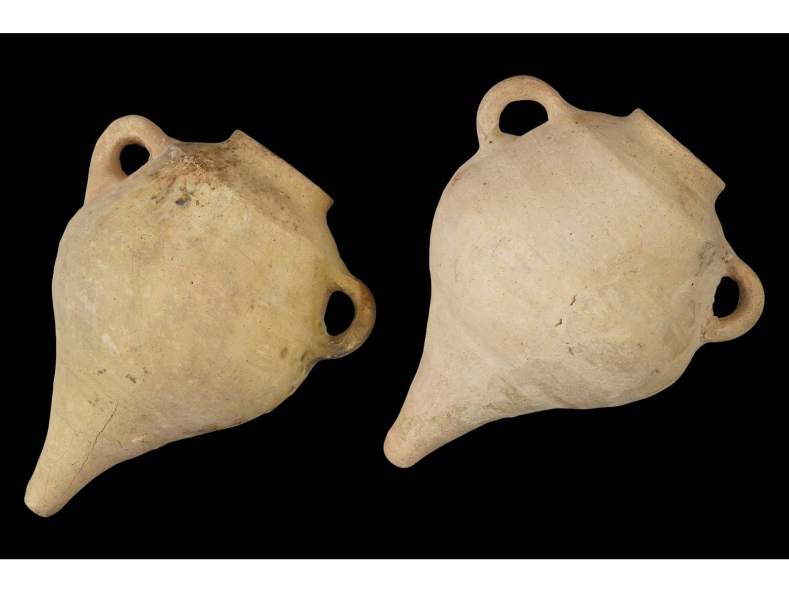 NCIENT BYZANTINE EMPIRE TERRACOTTA WINE AMPHORAS: A pair of ancient Byzantine Empire terracotta pottery handled wine amphoras. Circa: 300 to 600 AD. Both have a cone shaped bottom, a wide mouth, and a pair of curved handles. Archaeological Finds And 