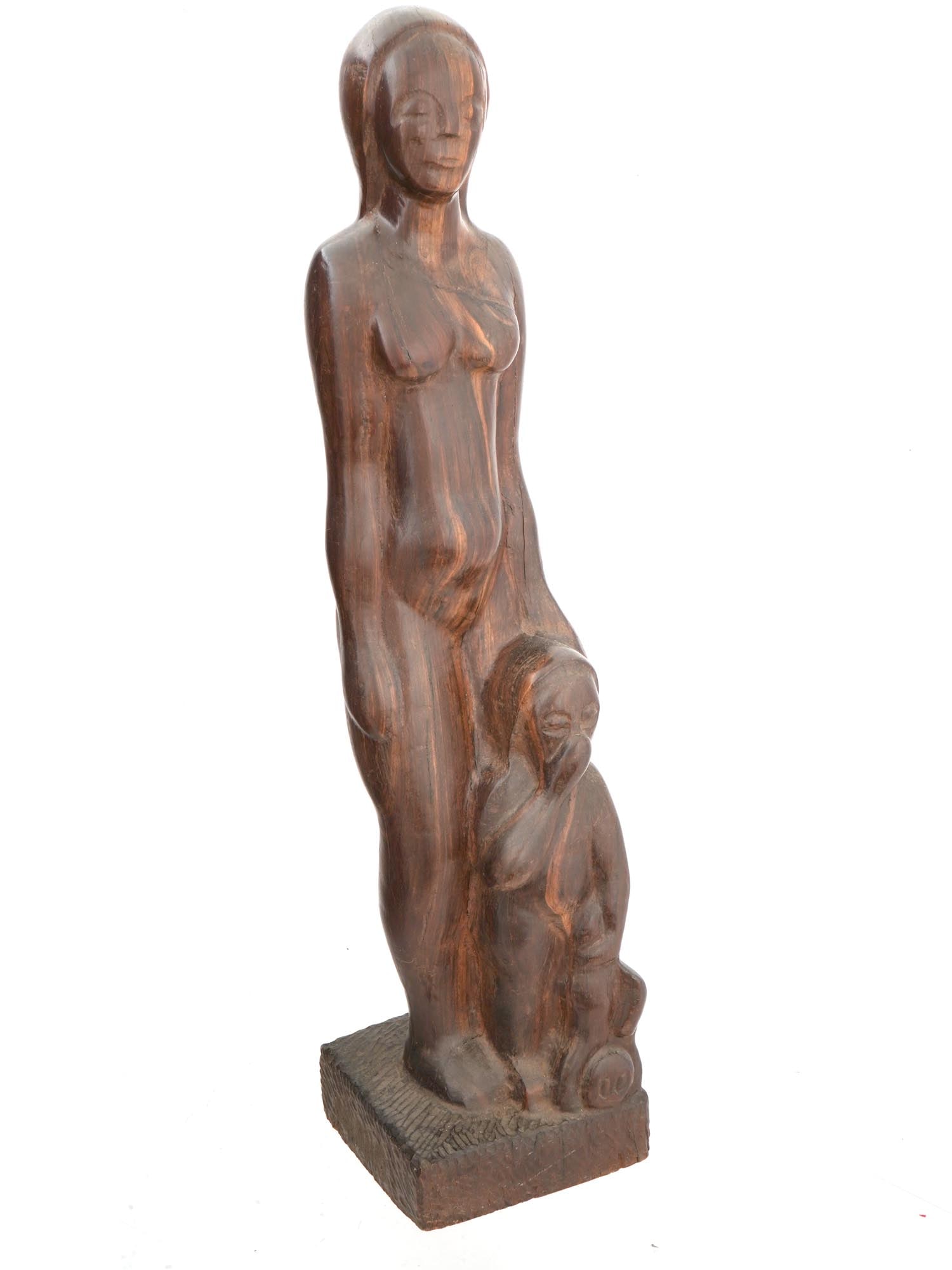 VINTAGE MOTHER AND CHILD WOODEN SCULPTURE: A vintage Mother And Child wooden sculpture. Circa mid to late 20th century. The artwork represents a standing figure of a naked young mother with closed eyes and a small child covering his nose and m