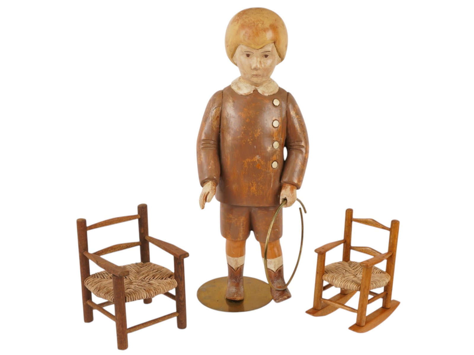 VINTAGE ITALIAN CARVED WOOD TOY SET BY SARREID: A vintage, mid-century, Italian carved wood toy set by Sarreid. The lot includes a large, ochre-painted figure of a boy with a hula hoop and two chairs with woven seats, one of which is a rocking chai