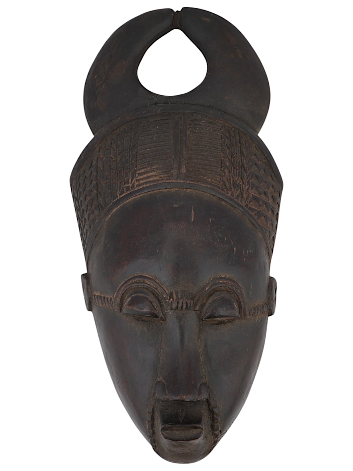 WEST AFRICAN BAULE PEOPLE WOOD MASK FROM IVORY COAST: A West African Baule people hand carved wooden mask from Ivory Coast. The Baule people are known for their intricate and expressive masks, which are often used in traditional ceremonies and rituals. T