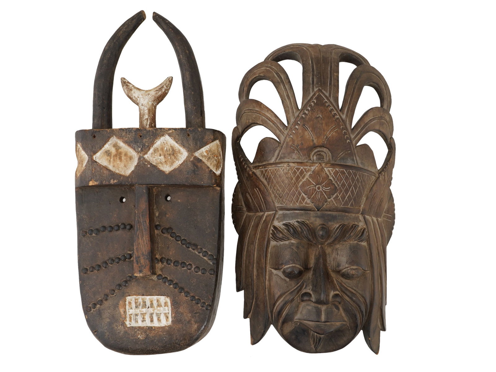 AFRICAN GUINEA HANDCRAFTED CARVED WOOD MASKS: A lot of two African handcrafted carved wood masks. The first item is a landai mask created by the Toma people of Guinea. The second mask depicts a beautifully detailed, realistic male face wearing a 
