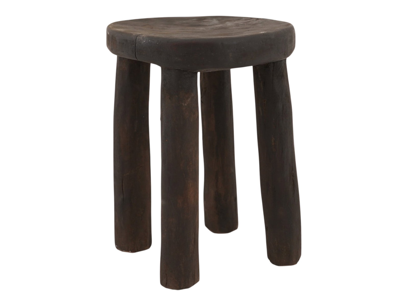 AFRICAN WOOD SENUFO MILKING STOOL FROM IVORY COAST: A West African stool, often called a Senufo milking stool from Ivory Coast. These stools are traditionally hand carved from a single piece of wood. They are distinguished by their sturdy, simple desig