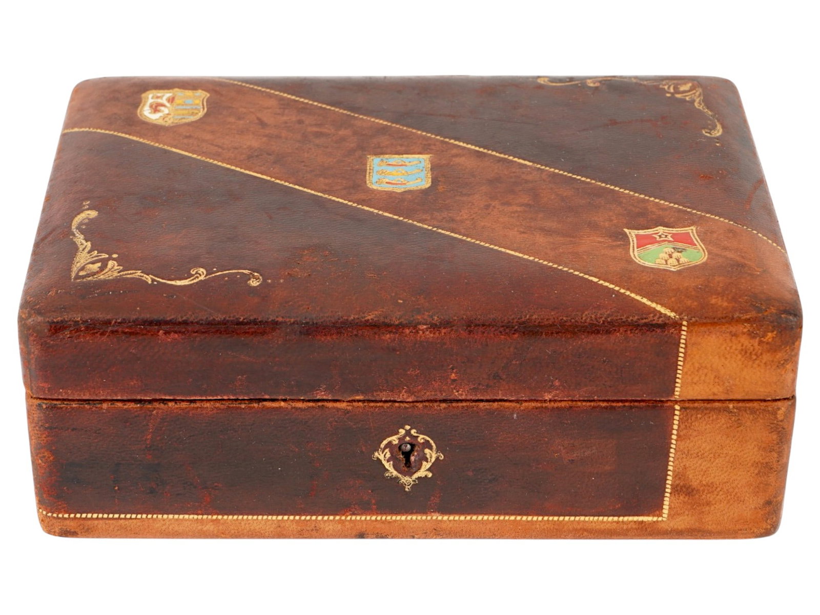 ANTIQUE ITALIAN WOODEN GENUINE LEATHER BOX: An antique Italian wooden box covered with genuine leather. Circa the late 19th to early 20th century. The lid is embellished with gilt-tooled corner scrolls and three heraldic shield motifs. The inte