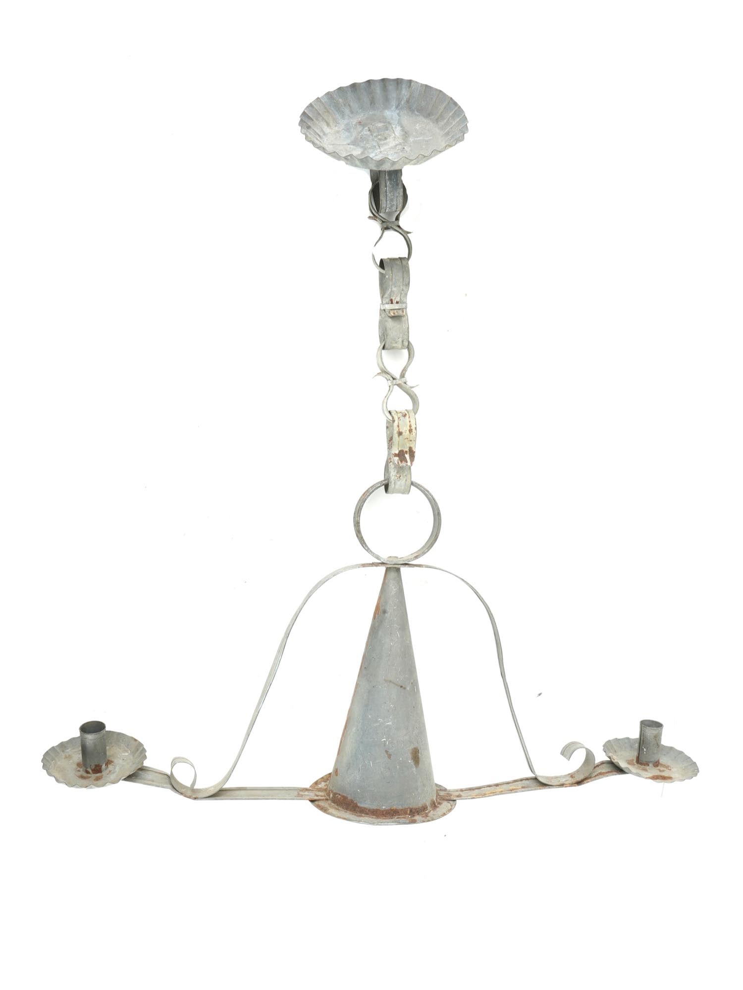 CONE SHAPED TIN CANDLE HOLDER WITH TWO ARMS: A tin candle holder with an intricate design features two candle holders on the sides. The central part is a cone shaped, connected to the side holders by curved pieces of tin. The top part is connect