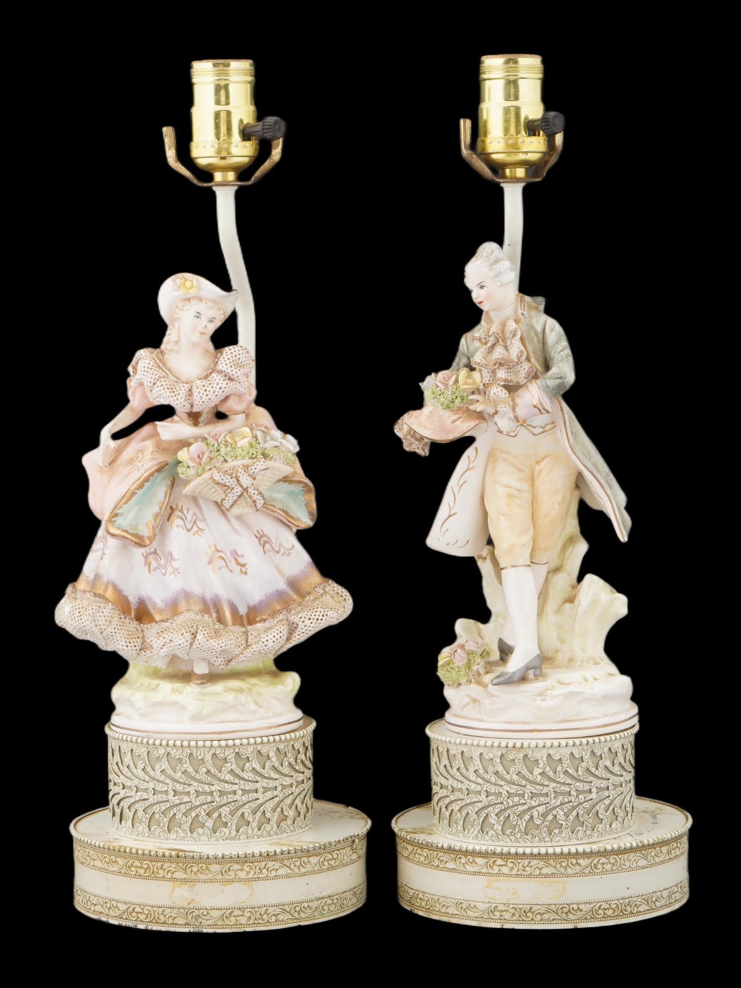 VINTAGE CAPODIMONTE STYLE PORCELAIN FIGURINE LAMPS: A pair of vintage Capodimonte-style porcelain lamps, featuring elaborately modeled and hand-painted figurines, a lady and gentleman in 18th-century attire. These lamps likely date to the mid-20th cent