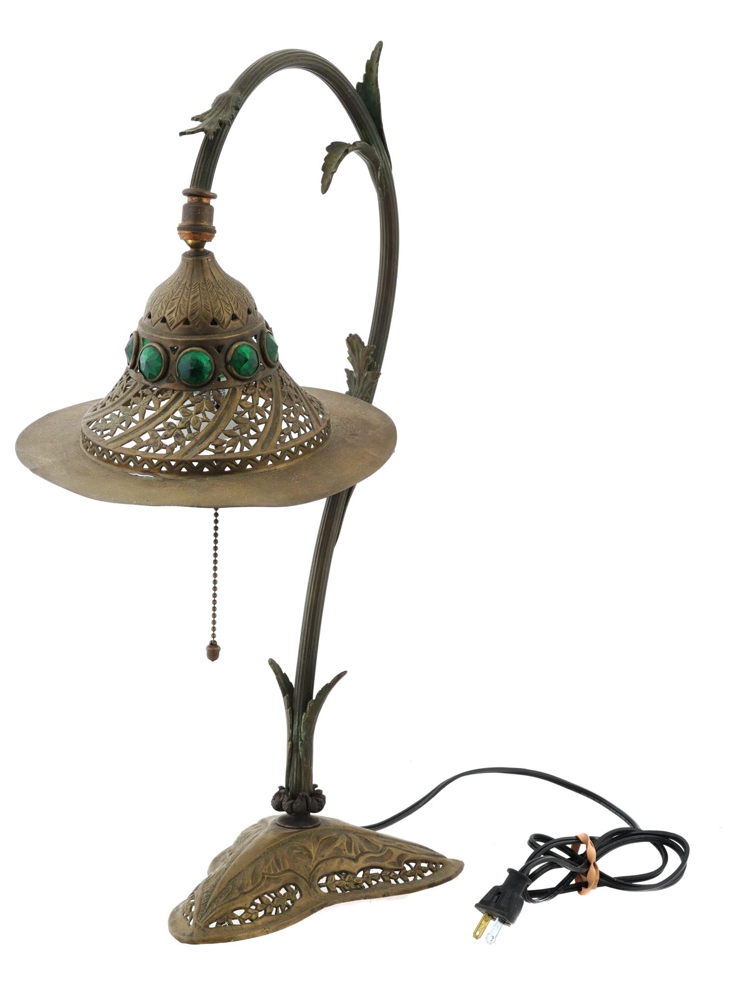 ART NOUVEAU MANNER GREEN GLASS BRASS DESK LAMP: A vintage Art Nouveau manner brass table lamp. The lamp is made in a floral stem design with leaves. A lamp is adorned with engraved foliage and floral ornaments, pierced through elements, and jewelle