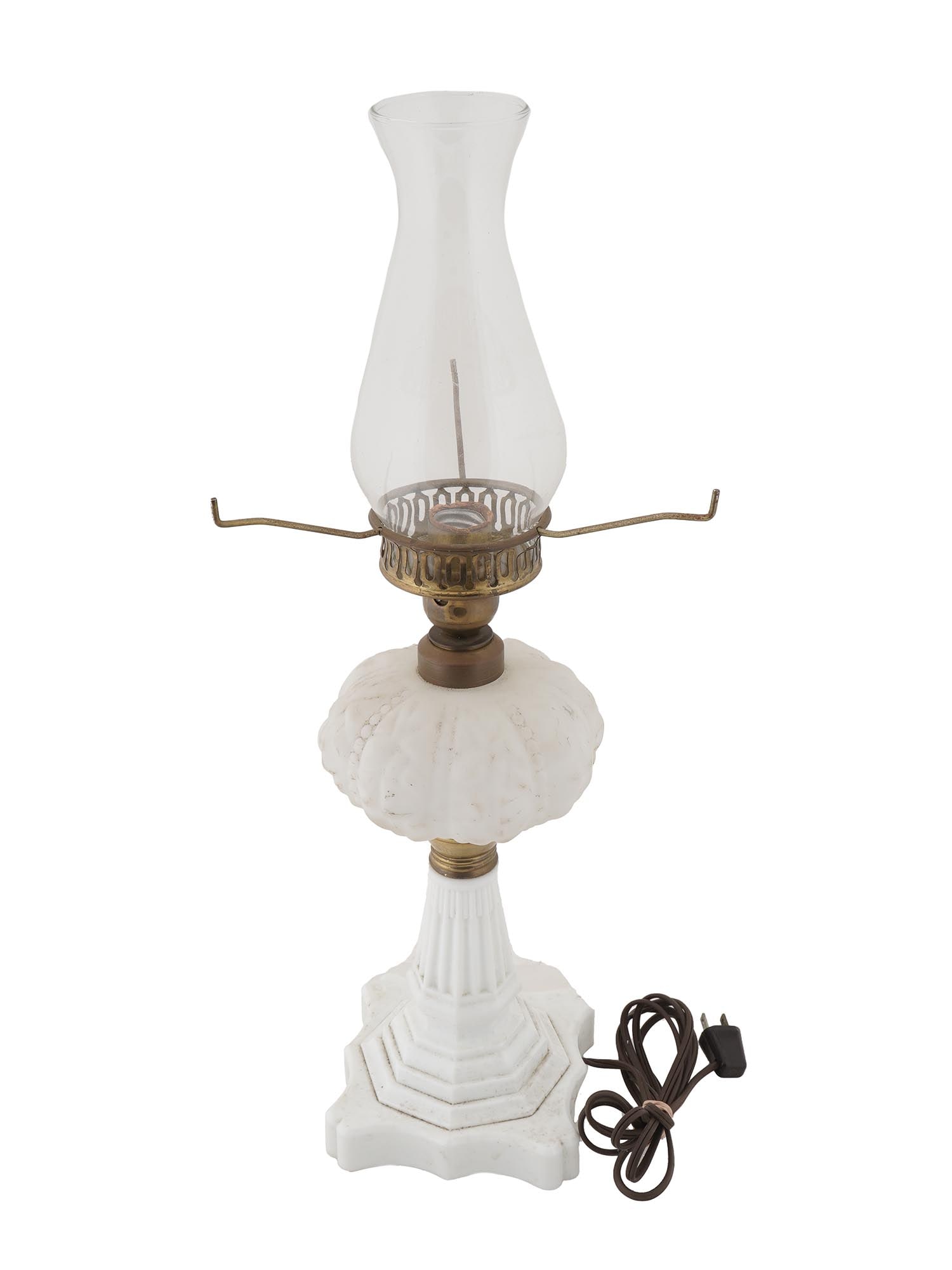 UNDERWRITERS LABORATORIES INC POTRABLE OIL LAMP: A vintage oil lamp adapted to electricity, with a milk glass base and brass fittings. Original paper label on verso reads: Underwriters Laboratories Portable Lamp Issue No. M-4242. Desk Accessory, Tab
